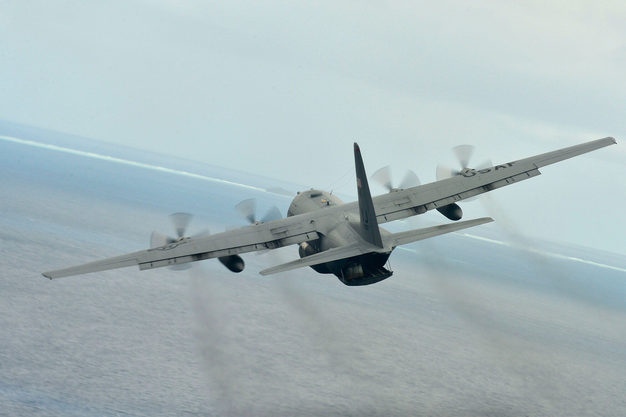 A C-130 Hercules with the 374th Airlift Wing, Yokota Air Base, Japan, conducts an airdrop mission during Operation Christmas Drop near Andersen Air Force Base, Guam, Dec. 16, 2013. This year marks the 62nd year of Operation Christmas Drop, which began in 1952, making it the world's longest running airdrop mission. Every December, C-130 Hercules crews from the 374th Airlift Wing at Yokota Air Base, Japan, partner with the 36th Wing at Andersen Air Force Base, Guam, to airlift food, supplies and toys to islanders throughout Micronesia. (U.S. Air Force photo by 2nd Lt. Jake Bailey/Released)