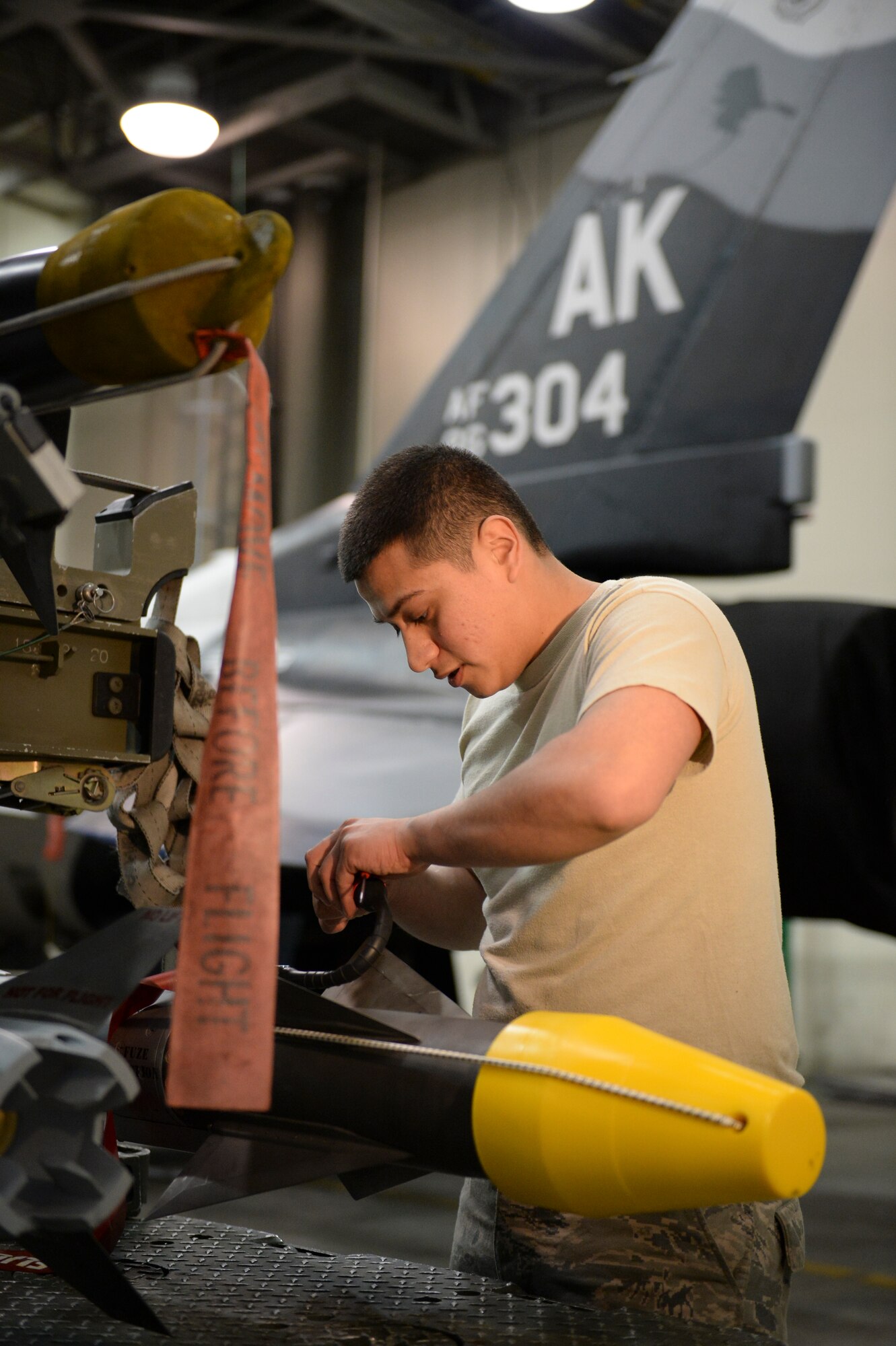 U.S. Air Force Airman 1st Class Uziel Huerta readies an AIM-9 Sidewinder missile for loading in an aircraft maintenance hangar during an annual load crew competition Dec. 13, 2013, Eielson Air Force Base, Alaska. The competition highlighted Eielson's top load crews in recognition for their outstanding performance and safety record throughout the year. (U.S. Air Force photo by Airman 1st Class Peter Reft/Released) 