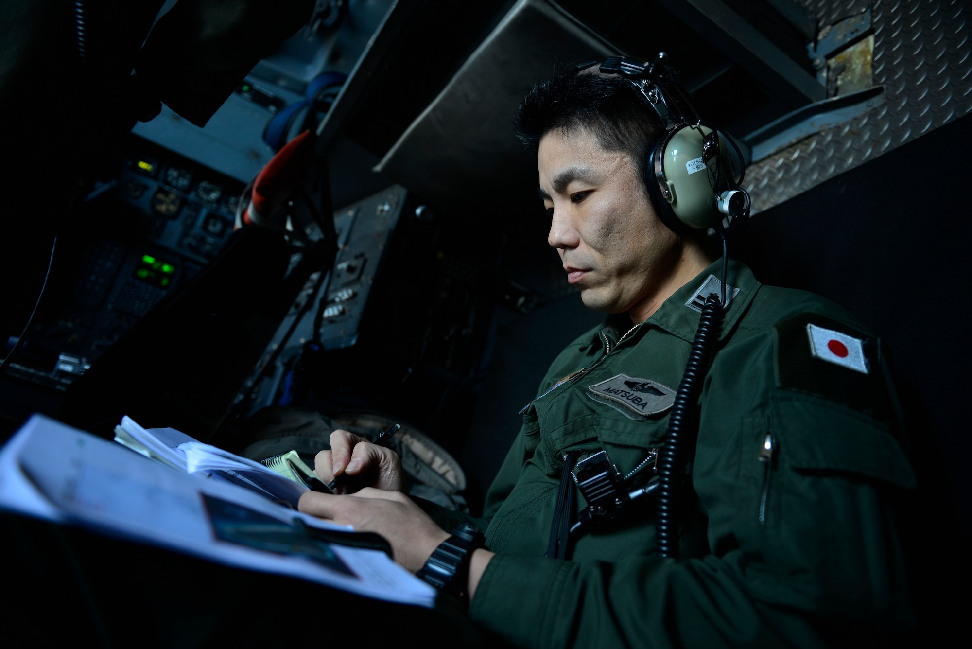 A Member of the Japan Air Self-Defense Force conducts an airdrop mission during Operation Christmas Drop at Andersen Air Force Base, Guam, Dec. 16, 2013. This year marks the 62nd year of Operation Christmas Drop, which began in 1952, making it the world's longest running airdrop mission. Every December, C-130 Hercules crews from the 374th Airlift Wing at Yokota Air Base, Japan, partner with the 36th Wing at Andersen Air Force Base, Guam, to airlift food, supplies and toys to islanders throughout Micronesia. (U.S. Air Force photo by 2nd Lt. Jake Bailey/Released)