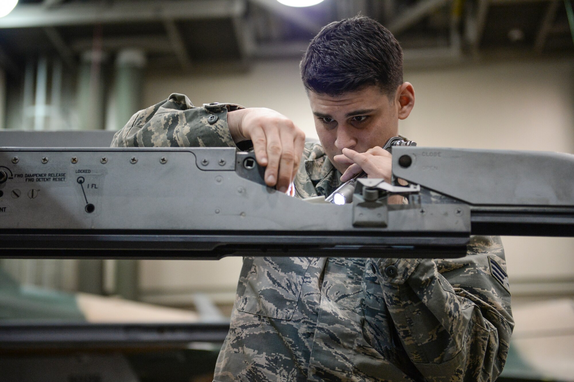 U.S. Air Force Senior Airman Joseph Levin, 354th Aircraft Maintenance Squadron weapons load crew member, inspects an F-16 Fighting Falcon launcher 129 in an aircraft maintenance hangar during an annual load crew competition Dec. 13, 2013, Eielson Air Force Base, Alaska. Levin and the other load crew members inspected and readied the aircraft before a timed weapons loading event. (U.S. Air Force photo by Airman 1st Class Peter Reft/Released)