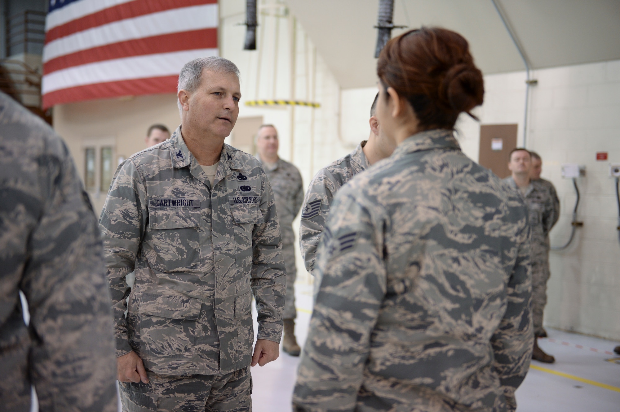 U.S. Air Force Col. John Cartwright, 354th Maintenance Group commander, performs uniform inspections on weapons load crew members in an aircraft maintenance hangar during an annual load crew competition Dec. 13, 2013, Eielson Air Force Base, Alaska. A uniform inspection is one of the factors in determining the overall score for each load crew. (U.S. Air Force photo by Airman 1st Class Peter Reft/Released)