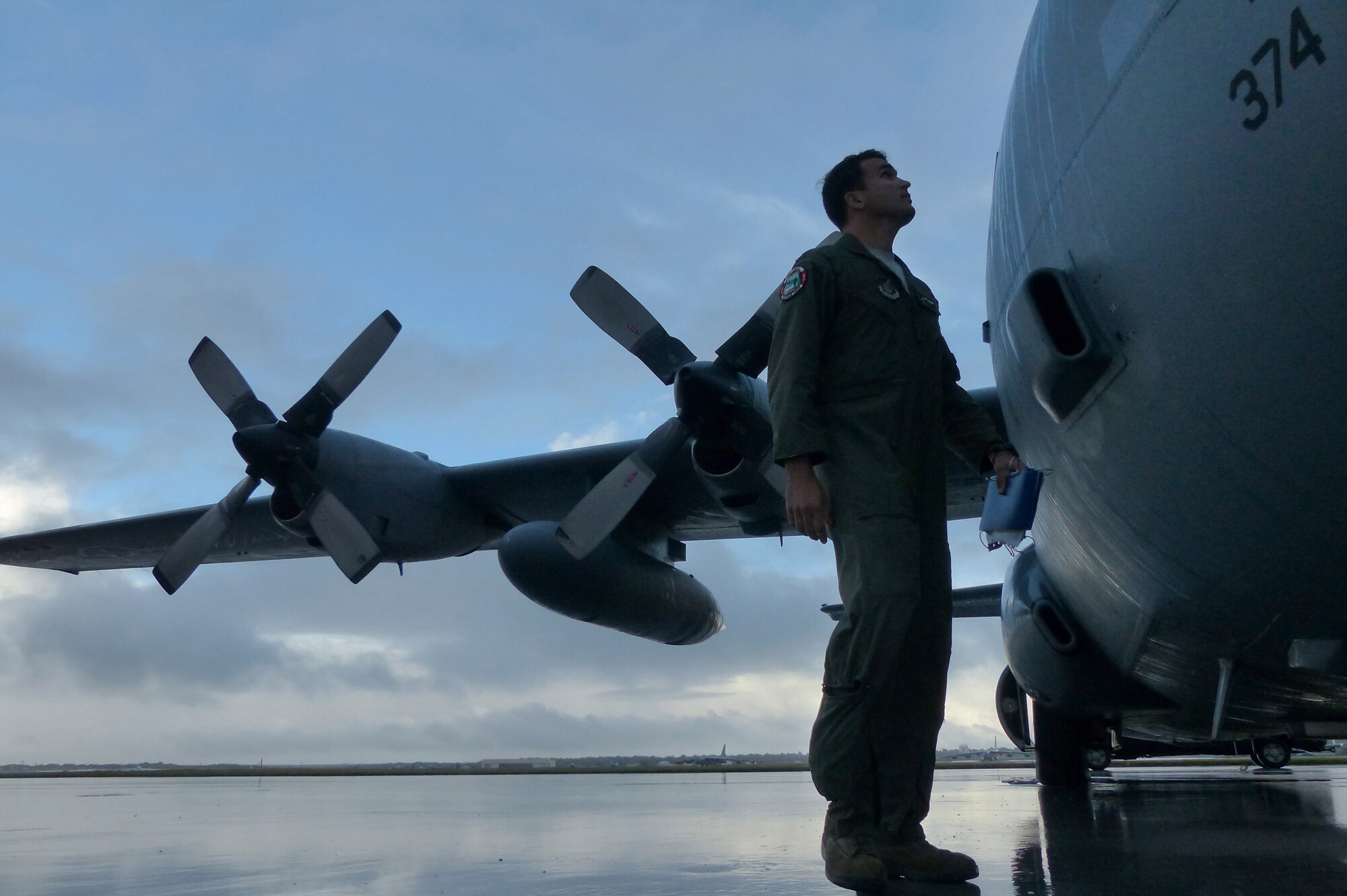 Capt. Travis Patton, a C-130H pilot assigned to the 36th Airlift Squadron, Yokota Air Base, Japan, conducts a preflight walk around inspection before an airdrop mission during Operation Christmas Drop at Andersen Air Force Base, Guam, Dec. 15, 2013. This year marks the 62nd year of Operation Christmas Drop, which began in 1952, making it the world's longest running airdrop mission. Every December, C-130 Hercules crews from the 374th Airlift Wing at Yokota Air Base, Japan, partner with the 36th Wing at Andersen Air Force Base, Guam, to airlift food, supplies and toys to islanders throughout Micronesia. (U.S. Air Force photo by 2nd Lt. Jake Bailey/Released)