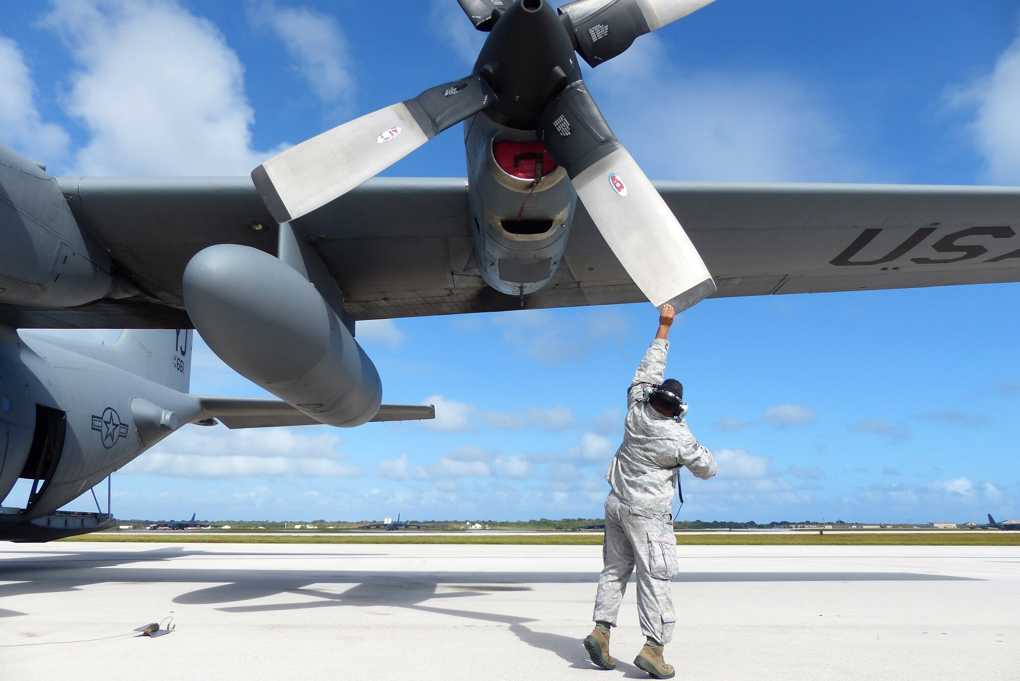 Staff Sgt. Stephen Naylor, 374th Aircraft Maintenance Squadron crew chief, Yokota Air Base, Japan, turns a C-130H aircraft prop to remove an engine plug before an airdrop mission during Operation Christmas Drop at Andersen Air Force Base, Guam, Dec. 14, 2013. This year marks the 62nd year of Operation Christmas Drop, which began in 1952, making it the world's longest running airdrop mission. Every December, C-130 Hercules crews from the 374th Airlift Wing at Yokota Air Base, Japan, partner with the 36th Wing at Andersen Air Force Base, Guam, to airlift food, supplies and toys to islanders throughout Micronesia. (U.S. Air Force photo by 2nd Lt. Jake Bailey/Released)