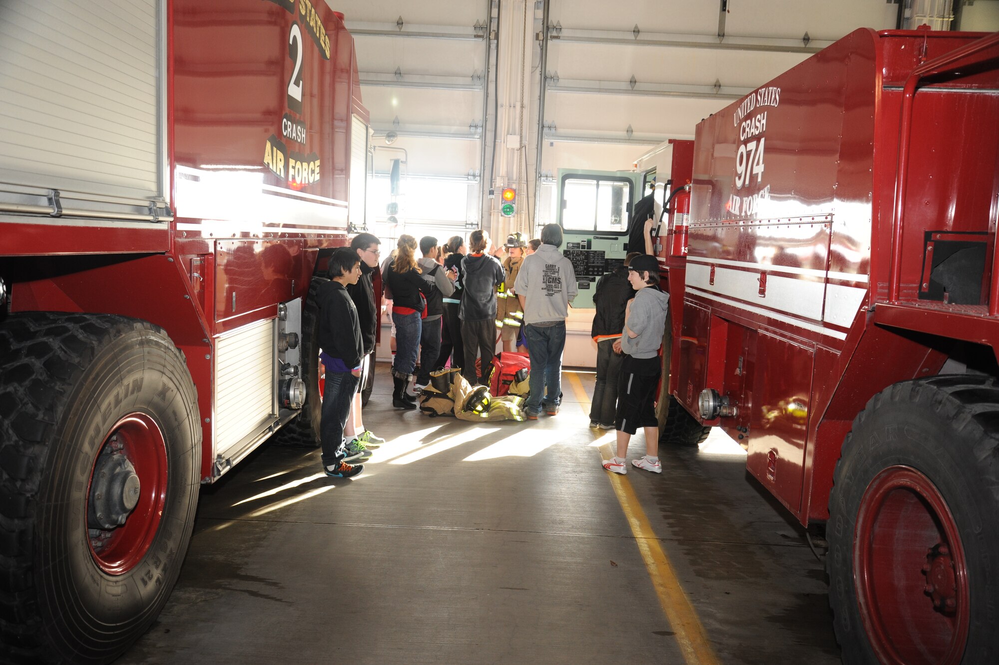 Garry Middle School students peruse firefighting tools at the fire department at Fairchild Air Force Base, Wash., Dec. 17, 2013.  The students toured the base to get a better grasp of their community.  (U.S. Air Force photo by Airman 1st Class Sam Fogleman/Released)