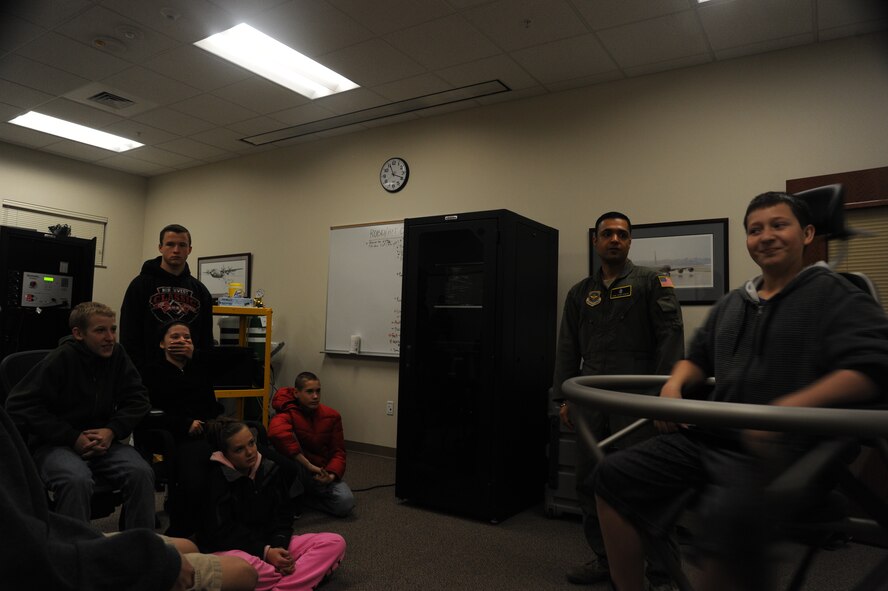 Staff Sgt. Vikas Kumar, 92nd Aerospace Medicine Squadron aerospace and operational physiology NCO in charge, spins a Garry Middle School student in the Barany chair at Fairchild Air Force Base, Wash., Dec. 17, 2013.  Spinning on the Barany chair helps Airmen understand spatial disorientation and learn to trust their instruments.  (U.S. Air Force photo by Airman 1st Class Sam Fogleman/Released)