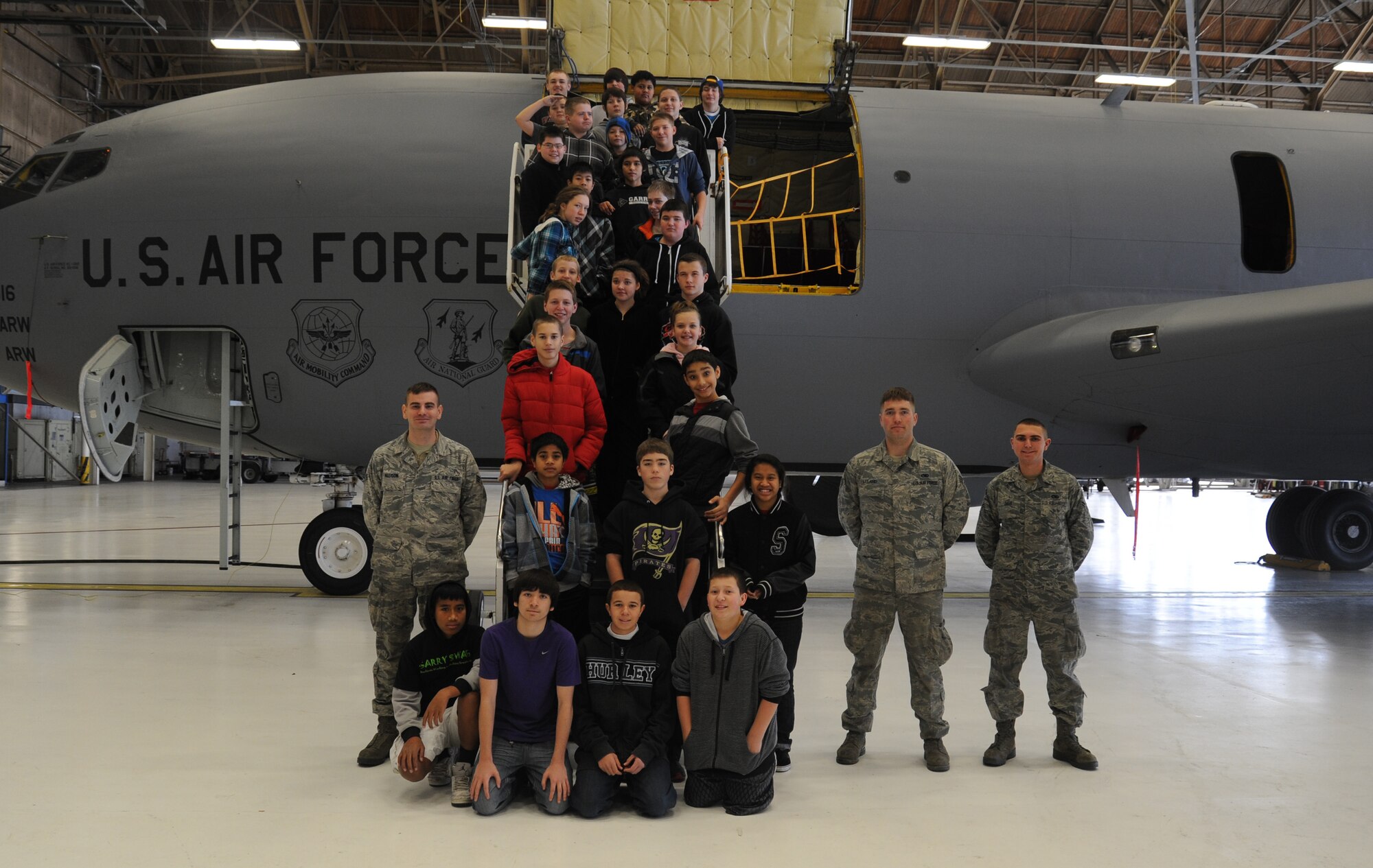 Airmen from the 92nd Aircraft Maintenance Squadron pose for a photo with Garry Middle School students at Fairchild Air Force Base, Wash., Dec. 17, 2013.  The tour was conducted to give the students greater insight into their community.  (U.S. Air Force photo by Airman 1st Class Sam Fogleman/Released)