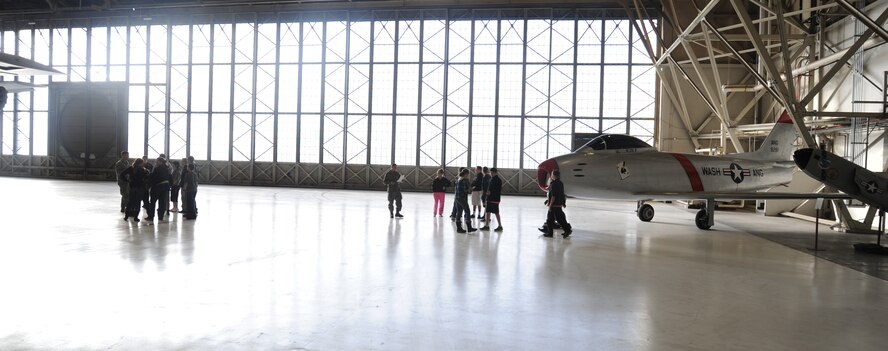 Garry Middle School students peruse parts of one of the aircraft hangars at Fairchild Air Force Base, Wash., Dec. 17, 2013.  The students toured the base to learn more about the Spokane area.  (U.S. Air Force photo by Airman 1st Class Sam Fogleman/Released)