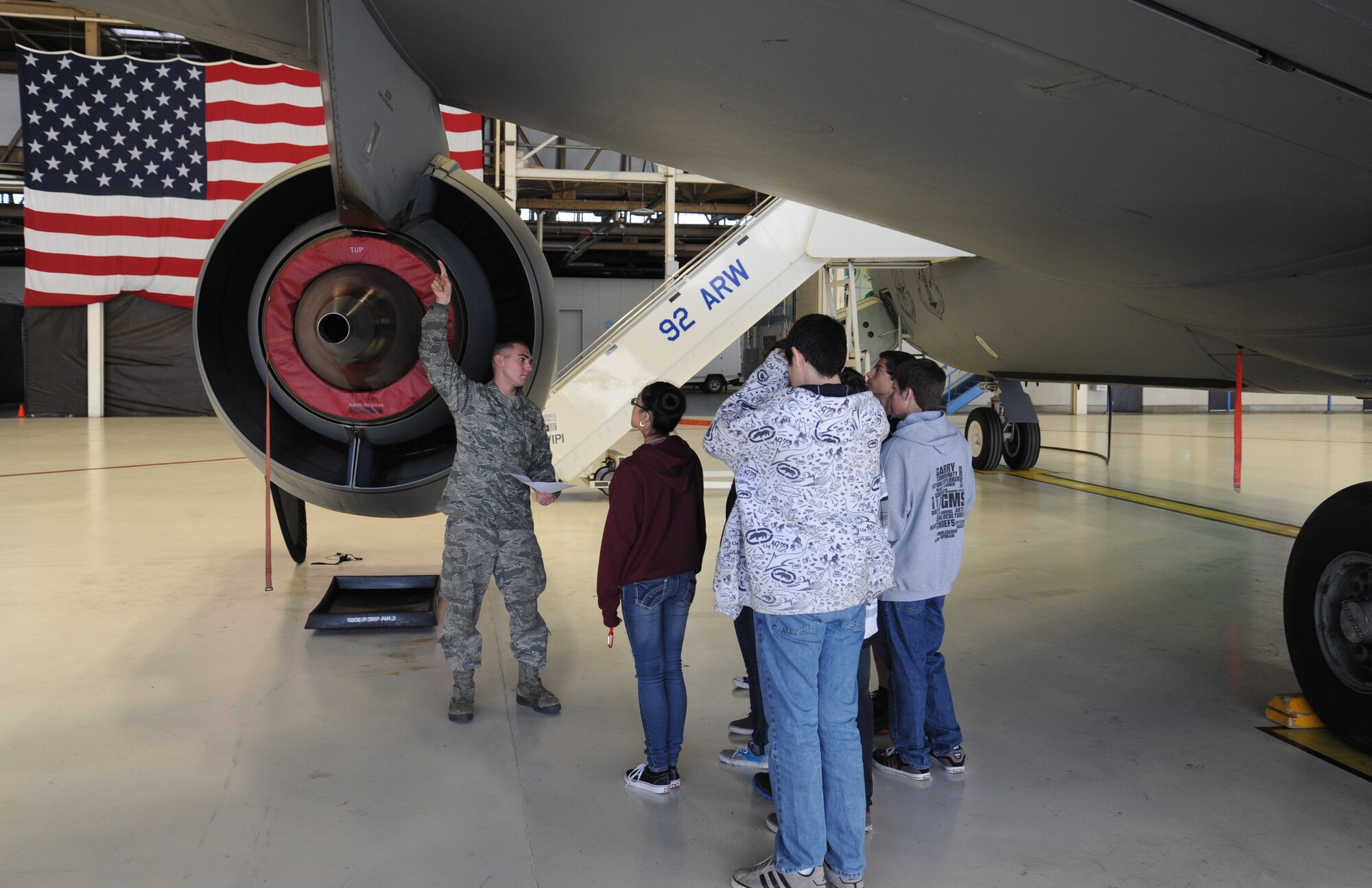 Airman 1st Class Josh Dark, 92nd Aircraft Maintenance Squadron aerospace maintenance apprentice, shows Garry Middle School students part of a KC-135 aircraft at Fairchild Air Force Base, Wash., Dec. 17, 2013.  The KC-135 was toured so students could understand a critical part of Fairchild's mission.  (U.S. Air Force photo by Airman 1st Class Sam Fogleman/Released)