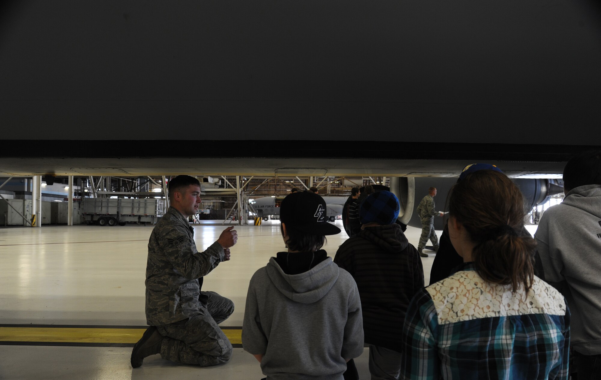 Senior Airman Nick Leland, 92nd Aircraft Maintenance Squadron assistant flying crew chief, shows Garry Middle School students the lower panel of a KC-135 aircraft at Fairchild Air Force Base, Wash., Dec. 17, 2013.  The students toured parts of one of the base hangars to see part of Fairchild's mission.  (U.S. Air Force photo by Airman 1st Class Sam Fogleman/Released)