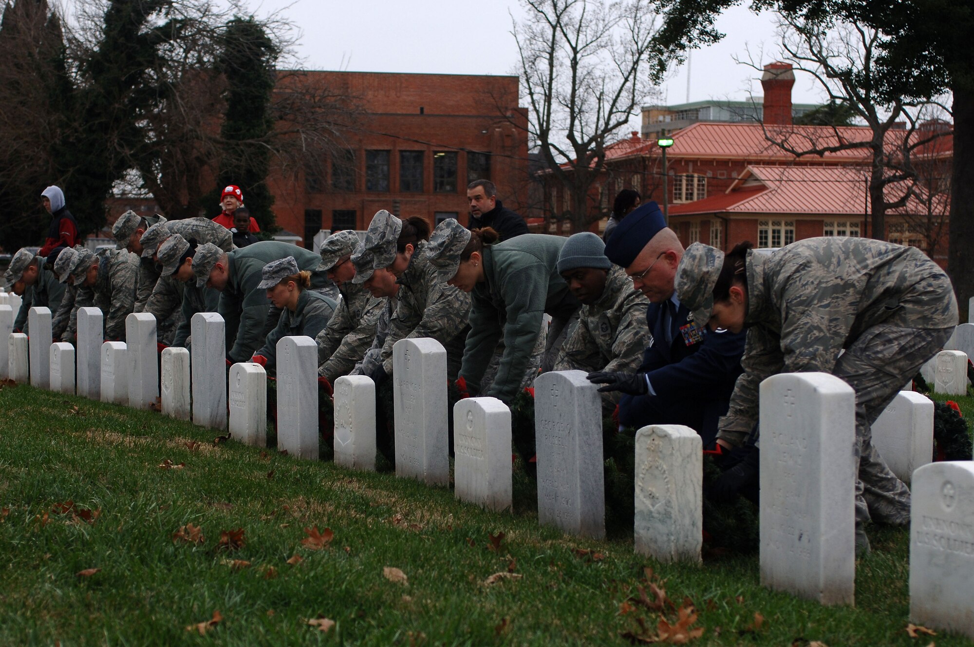 U.S. Air Force Airmen lay wreaths on gravesites of veterans during the “Wreaths Across America” program at the Hampton National Veteran Cemetery in Hampton, Va., Dec. 14, 2013.  “Wreaths Across America” is an annual program which provides wreaths on headstones at veteran cemeteries across the nation and American cemeteries around the world. (U.S. Air Force photo by Senior Airman Teresa Aber/Released)