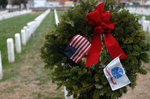 Volunteers laid holiday wreaths on the grave sites of Service members during the “Wreaths Across America” program at the Hampton National Veteran Cemetery in Hampton, Va., Dec. 14, 2013. Military personnel and members of the local community laid more than 7,000 wreaths at national veteran cemeteries in Hampton Roads. (U.S. Air Force photo by Senior Airman Teresa Aber/Released)