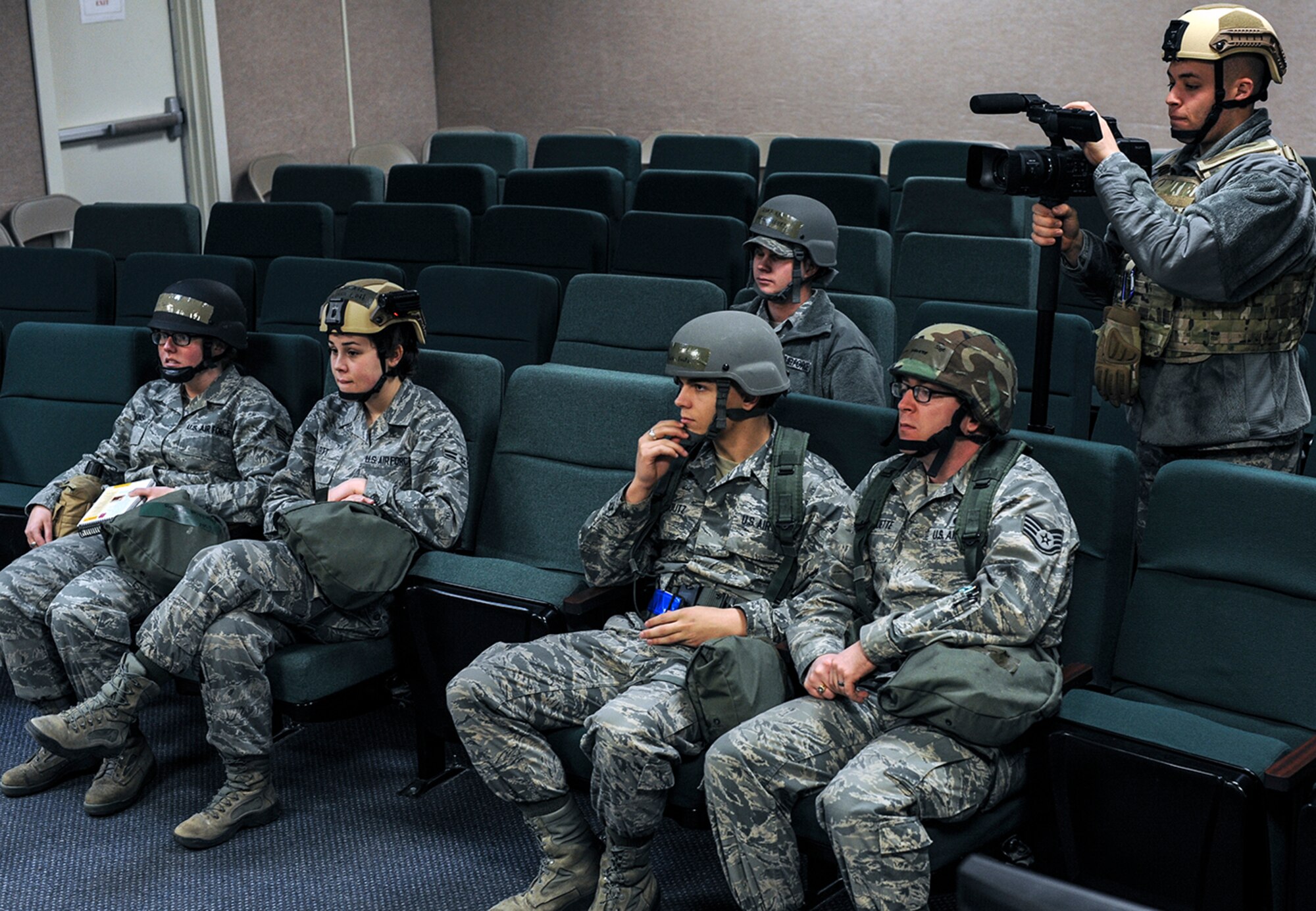 366th Fighter Wing Staff Airmen attend a deployment briefing during a readiness exercise at Mountain Home Air Force Base, Idaho, Dec. 17, 2013. The Airmen learned self-aid and buddy care techniques and proper litter carry during the briefing. (U.S. Air Force photo by Master Sgt. Kevin Wallace/RELEASED)