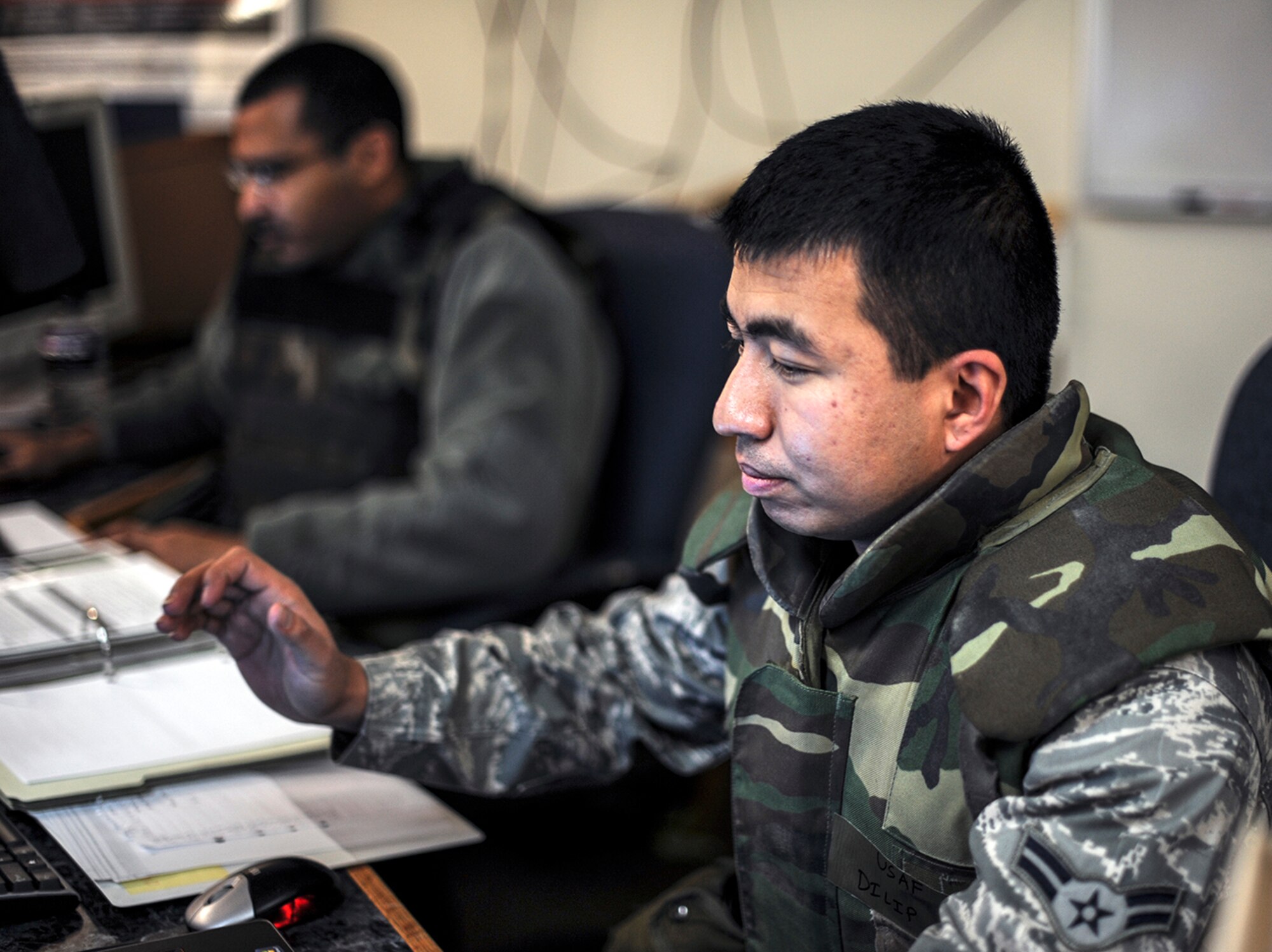 Air Force Airmen 1st Class Ryan Potter (left) and Dilip Pradhan, exercise unit control center operators ‘deployed’ from the 366th Comptroller Squadron, update information on an automated exercise information system during a readiness exercise at Mountain Home Air Force Base, Idaho, Dec. 17, 2013.  The comptrollers worked in conjuction with Airmen from contracting, the chapel, safety, the judge advocate office and public affairs during the exercise. (U.S. Air Force photo by Master Sgt. Kevin Wallace/RELEASED)