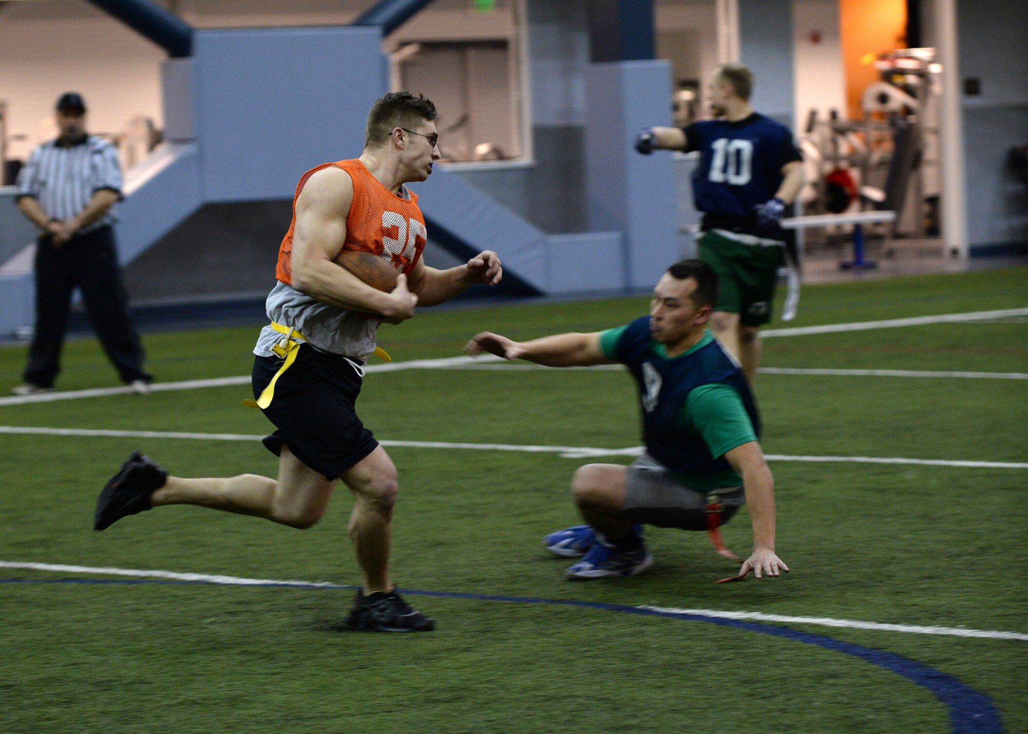 Senior Airman Michael White, 354th Maintenance Squadron receiver, runs the ball during the intramural football championship Dec. 16, 2013, Eielson Air Force Base, Alaska. The 168th Air Refueling Wing won the game 26-6. (U.S. Air Force photo by Senior Airman Shawn Nickel/Released)