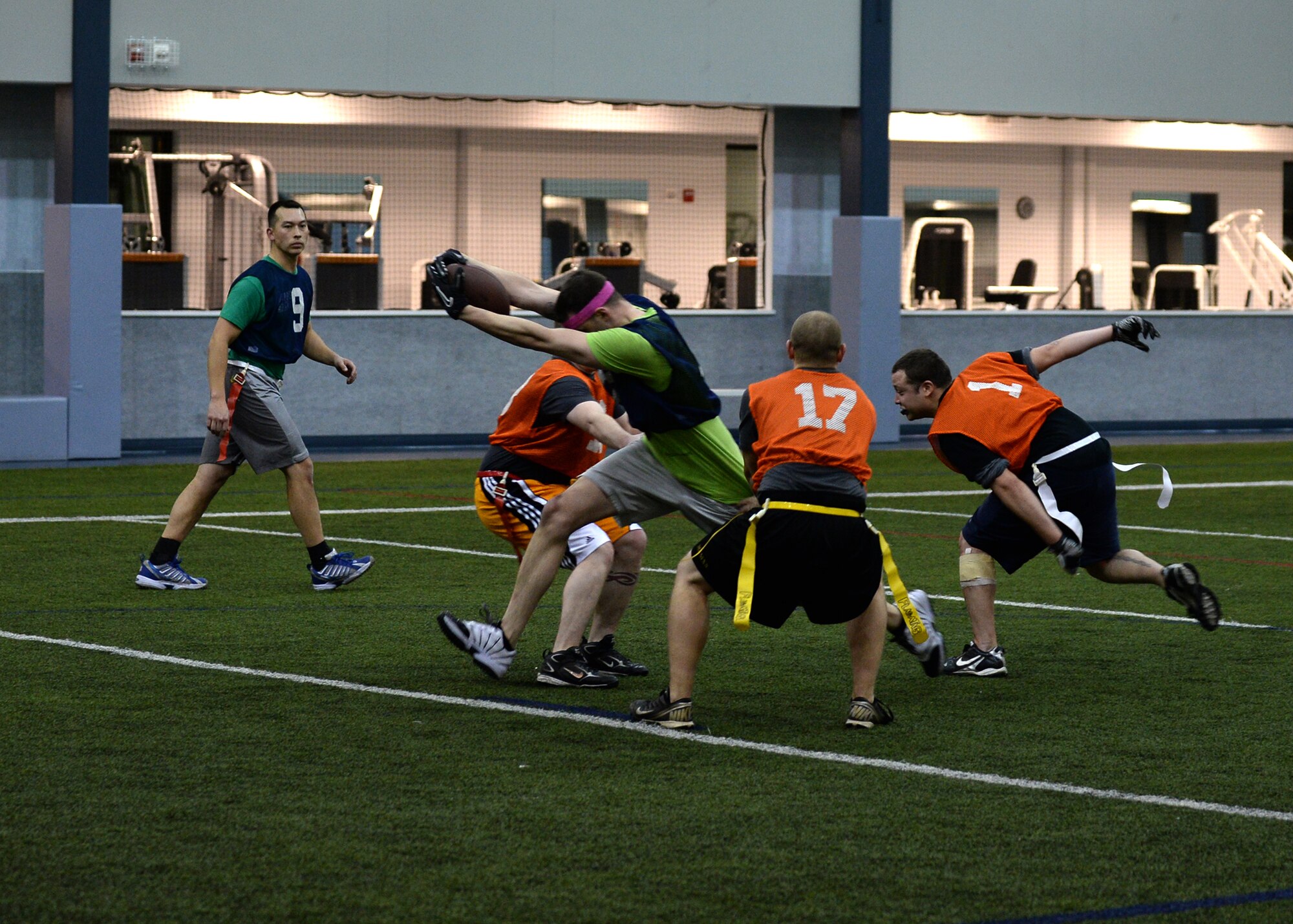 Senior Airman Shawn Hageman, 168th Air Refueling Wing center, runs the ball during a touchdown play at the intramural football championship Dec. 16, 2013, Eielson Air Force Base, Alaska. The team won the game 26-6 against the 354th Maintenance Squadron. (U.S. Air Force photo by Senior Airman Shawn Nickel/Released)