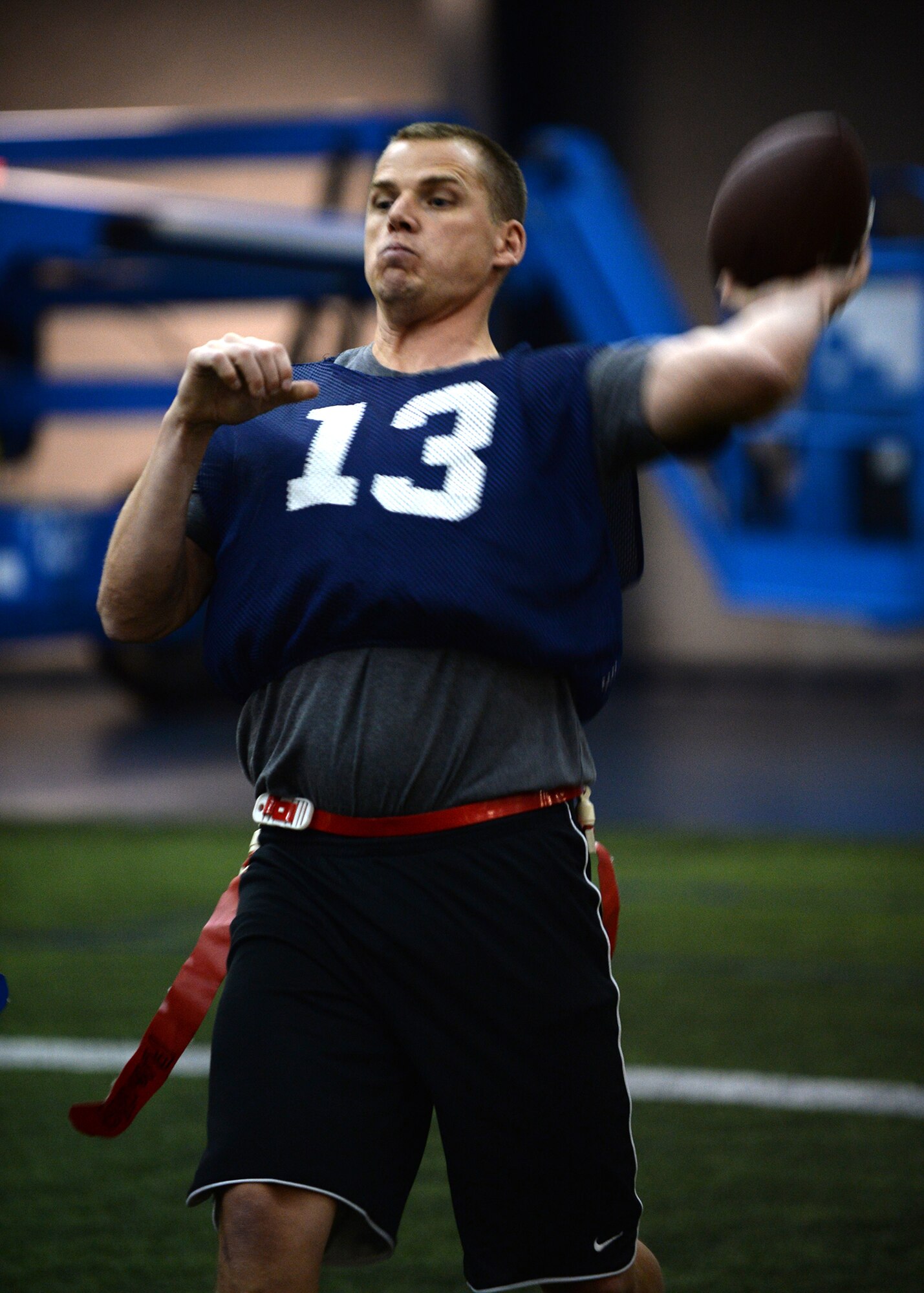 Tech. Sgt. Robert Parsons, 354th Maintenance Squadron receiver, runs a play after catching the ball during the intramural football championship Dec. 16, 2013, Eielson Air Force Base, Alaska. The 168th Air Refueling Wing won the game 26-6 against the 354th Maintenance Squadron. (U.S. Air Force photo by Senior Airman Shawn Nickel/Released)