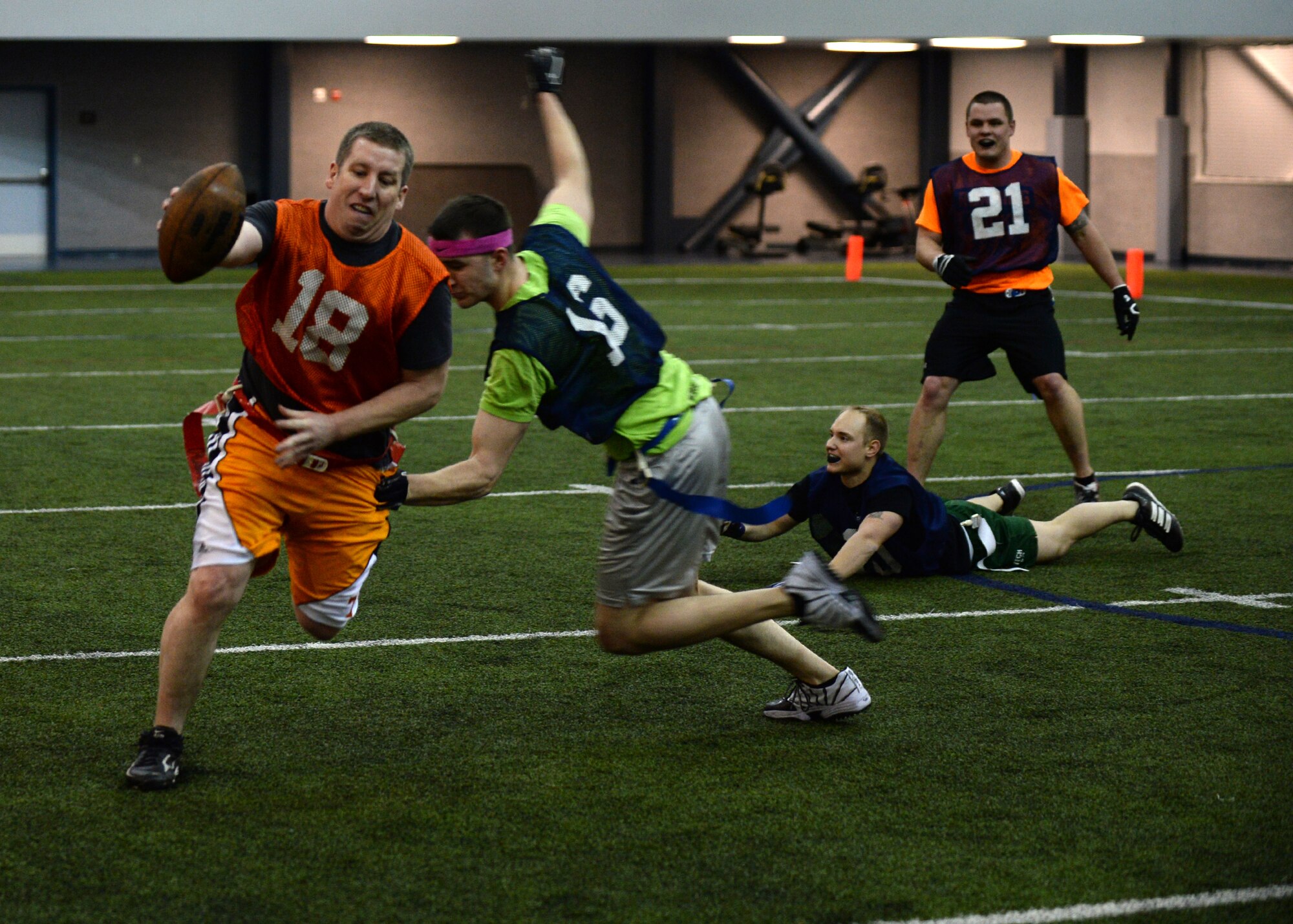 Tech. Sgt. Robert Parsons, 354th Maintenance Squadron receiver, runs a play after catching the ball during the intramural football championship Dec. 16, 2013, Eielson Air Force Base, Alaska. The 168th Air Refueling Wing won the game 26-6 against the 354th Maintenance Squadron. (U.S. Air Force photo by Senior Airman Shawn Nickel/Released)