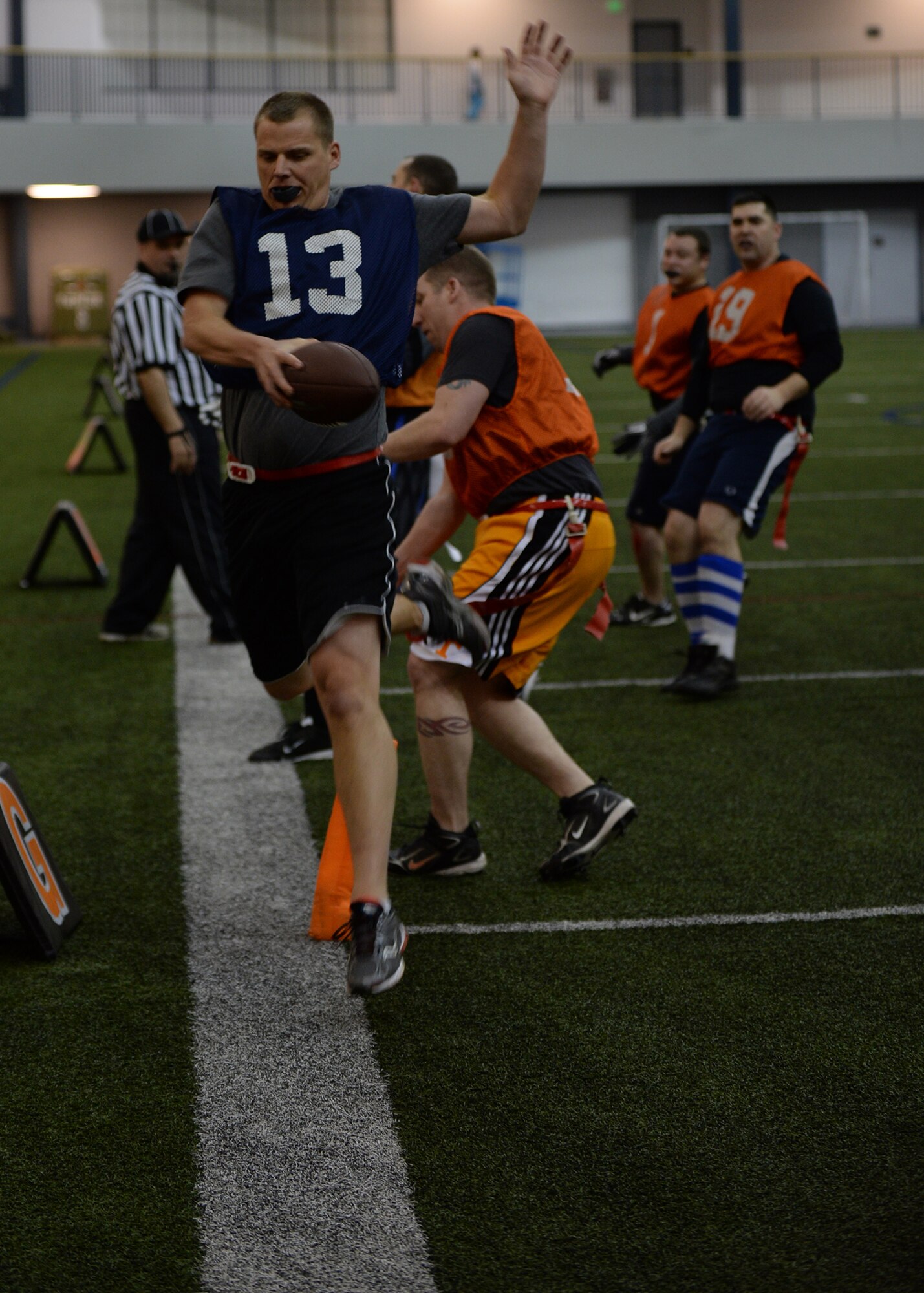 Senior Master Sgt. John Brunsberg, 168th Logistics Readiness Squadron quarterback, scores a touchdown on a running play during the intramural football championship Dec. 16, 2013, Eielson Air Force Base, Alaska. The team won the game 26-6 against the 354th Maintenance Squadron. (U.S. Air Force photo by Senior Airman Shawn Nickel/Released)