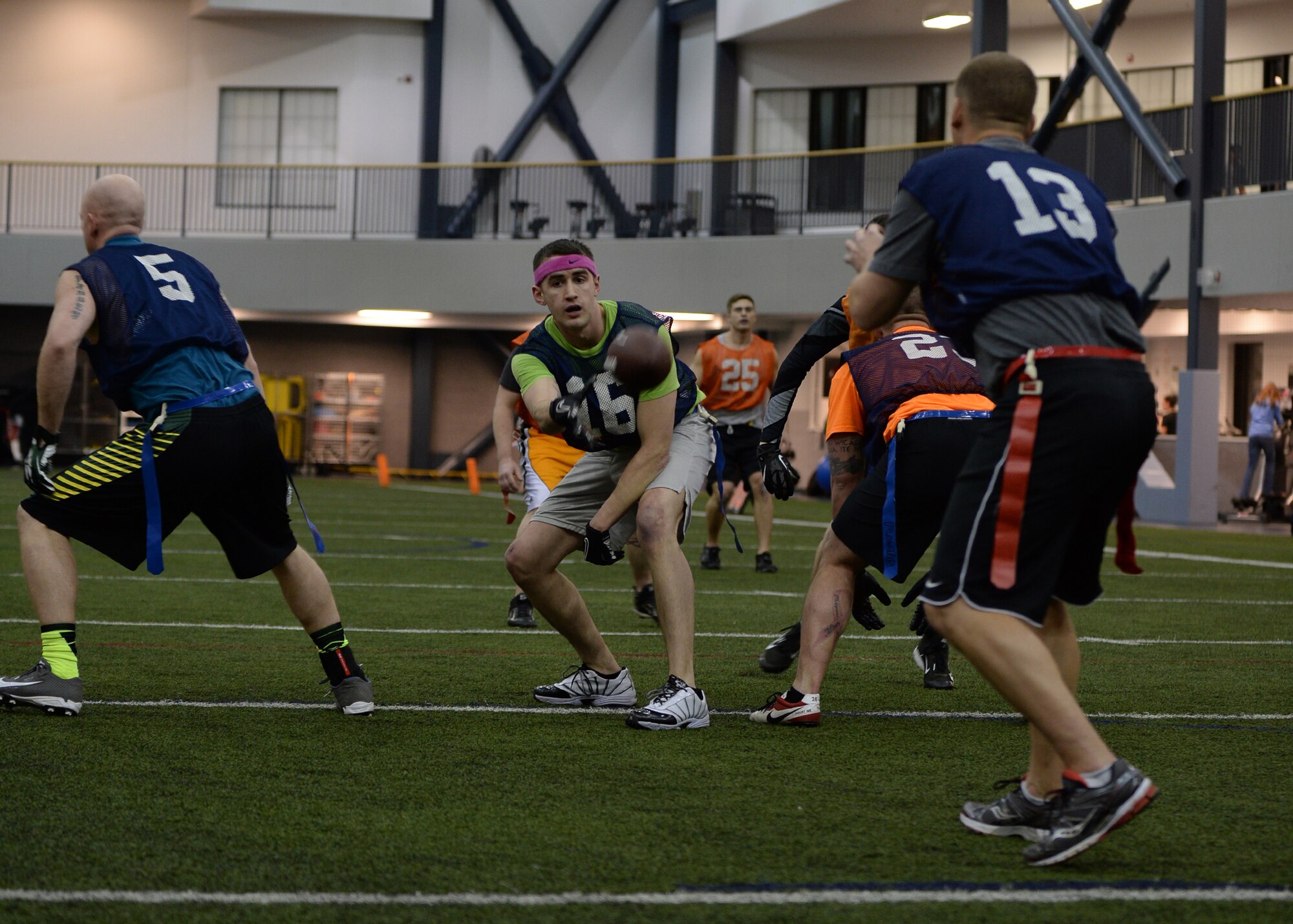 Senior Airman Shawn Hageman, 168th Air Refueling Wing center, passes the ball during a touchdown play at the intramural football championship Dec. 16, 2013, Eielson Air Force Base, Alaska. The team won the game 26-6 against the 354th Maintenance Squadron. (U.S. Air Force photo by Senior Airman Shawn Nickel/Released)