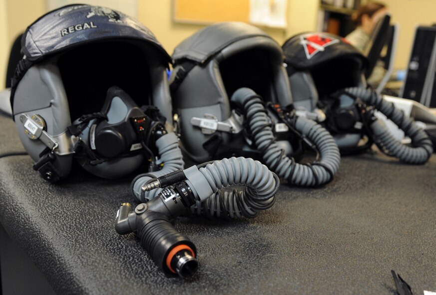 HGU-55P helmets sit on a table awaiting inspection on Barksdale Air Force Base, La., Dec. 17, 2013. Airmen from the 2nd Operational Support Squadron Aircrew Flight Equipment inspect the helmets every 30 days to ensure they work properly and continue to provide pilots and officers with basic head protection, sound attenuation, symbology, weapons cueing and a communication system for aircrew personnel. (U.S. Air Force photo/Senior Airman Joseph A. Pagán Jr.)