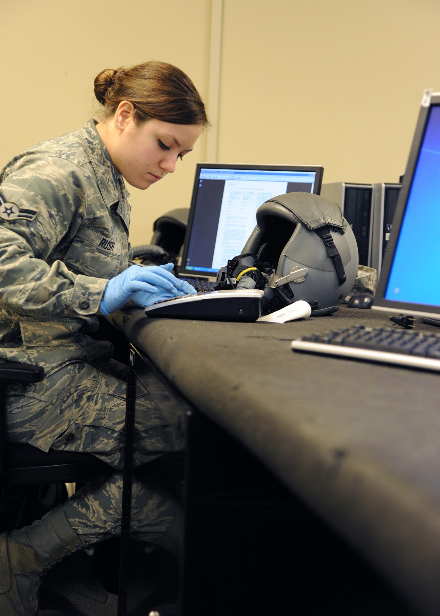 Airman 1st Class Kristin Rush, 2nd Operational Support Squadron Aircrew Flight Equipment journeyman, prints a tape label on Barksdale Air Force Base, La., Dec. 17, 2013. Rush used a P-Touch tape label to print out the next inspection date for a HGU-55P helmet. The helmet is inspected every 30 days to maintain its integrity. (U.S. Air Force photo/Senior Airman Joseph A. Pagán Jr.)