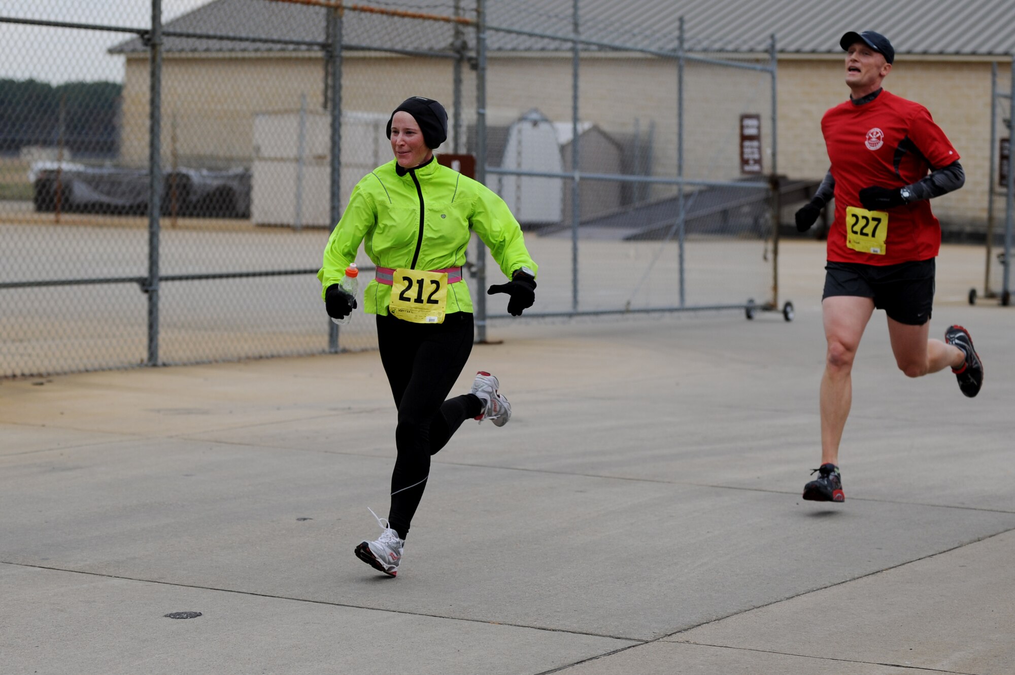 U.S. Air Force Maj. Carrie Wentzel, 633rd Force Support Squadron operations officer, sprints toward the finish line with Air Force Lt. Col. Dee J Katzer, 633rd Civil Engineer Squadron commander, during the 4th annual “Race ‘Round the Base” at Langley Air Force Base, Va., Dec. 14, 2013. The 10-mile race took runners around Langley, through base housing and alongside the flightline. (U.S. Air Force photo by Staff Sgt. Jarad A. Denton/Released)