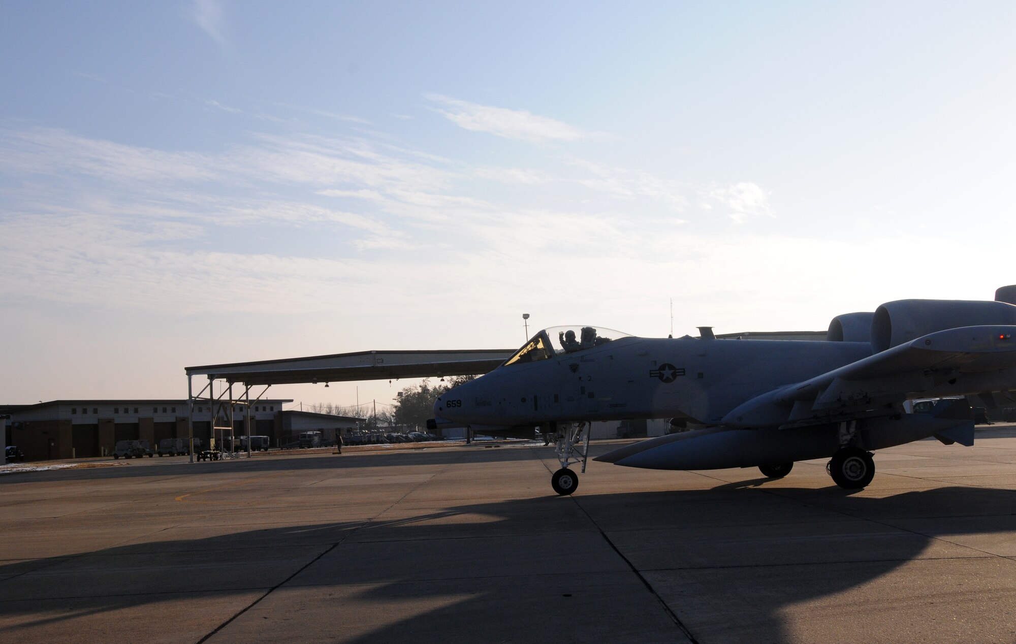 Col. Michael Stohler, a pilot with the Indiana Air National Guard's 122nd Fighter Wing, waves as he prepares to deliver an A-10C Thunderbolt II "Warthog" from the 188th Fighter Wing to the 122nd, Dec. 11, 2013. Tail Nos. 659 and 626 are bound for Fort Wayne, Ind., as part of the 188th’s on-going conversion from a fighter mission to remotely piloted aircraft and Intelligence mission, which will include a space-focused targeting squadron. (U.S. Air National Guard photo by Senior Airman John Hillier/188th Fighter Wing Public Affairs)