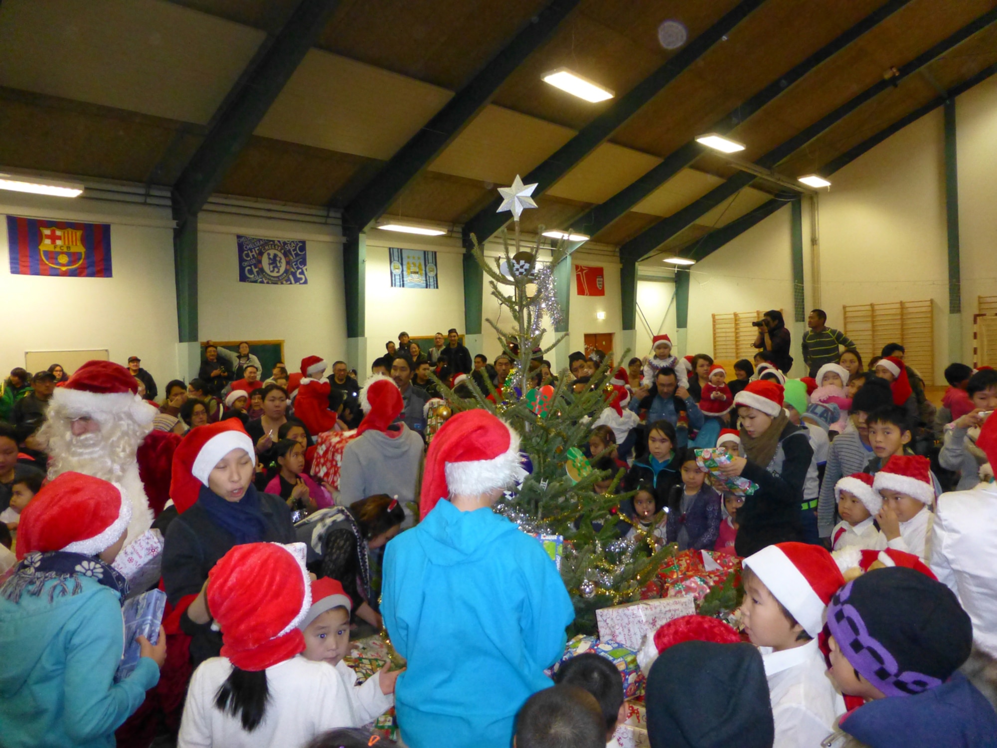QAANAAQ, Greenland – Julemand delivers gifts to children at Qaanaaq, Greenland, during Thule Air Base’s Operation Julemand. The multi-national effort is held annually by U.S., Danish and Canadian military and civilian employees at Thule to promote goodwill with the Greenlandic people. Julemand is Danish for “Christmas Man” and is the equivalent to Santa Claus. (U.S. Air Force photo/Capt. Laura Simmons)