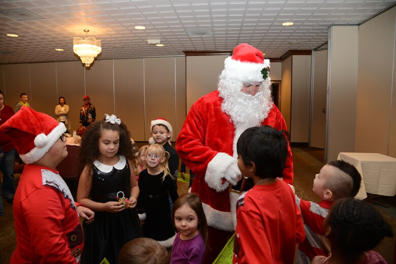 PETERSON AIR FORCE BASE, Colo. – Children from the exceptional family member program greet Santa during the 310th Space Wing’s junior enlisted council-sponsored Breakfast with Santa Dec. 14 at the Peterson Club. The event was exclusively for EFMP children and their families and included photos with Santa, face painting, magic tricks, balloon animals and speeches from representatives from the Special Olympics and the Olympic Training Center. (U.S. Air Force photo/Tech. Sgt. Jared Marquis)