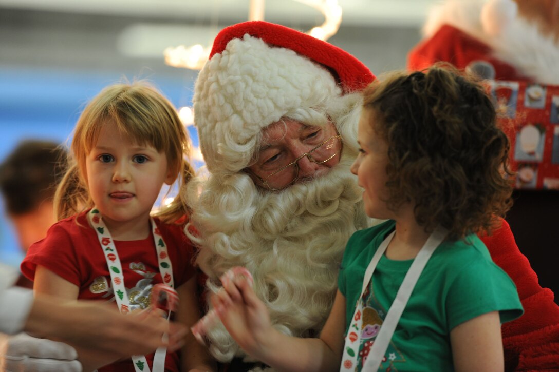 A visit with Santa Claus is the highlight of the party at the 26th Annual Parents and Children Fighting Cancer Christmas Party on Dec. 14, 2013 on Joint Base Andrews, Md. This event allowed PCFC families to spend the day in a winter wonderland offering food, entertainment, gifts, static displays, and a visit from Santa and Mrs. Claus. (U.S. Air Force photo/Aimee Fujikawa)