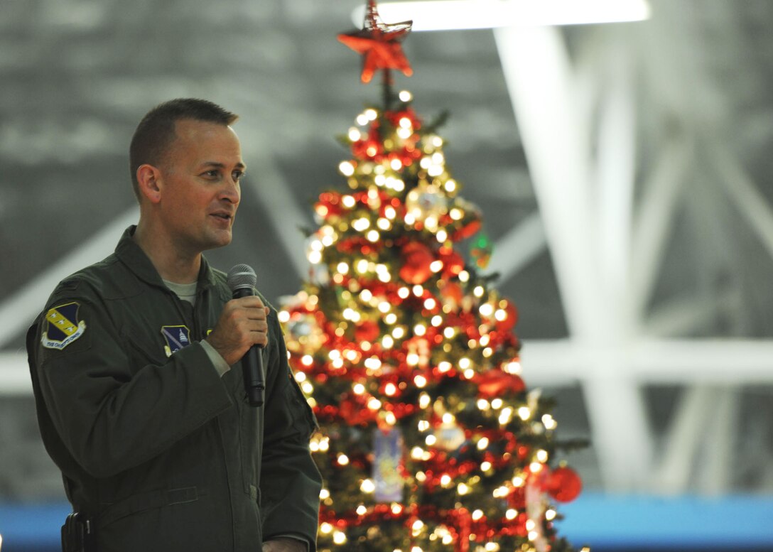 Col. Bill Knight, Joint Base Andrews/11th Wing commander, greets guests and announces the arrival of Santa and Mrs. Claus at the 26th Annual Parents and Children Fighting Cancer Christmas Party on Dec. 14, 2013. This event allowed PCFC families to spend the day in a winter wonderland offering food, entertainment, gifts, static displays, and a visit from Santa and Mrs. Claus. (U.S. Air Force photo/Aimee Fujikawa)
