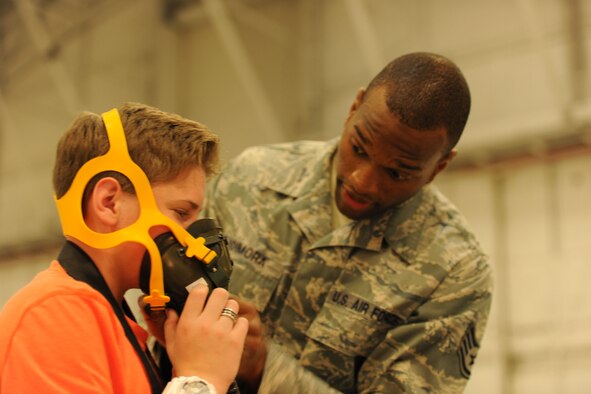 Staff Sgt. Isaac Adimora, 779th Aerospace Medicine Squadron and 79th Medical Wing flight medical technician, demonstrates proper use of medical equipment Dec. 14, 2013 at the 26th Annual Parents and Children Fighting Cancer Christmas Party on Joint Base Andrews, Md. This event allowed PCFC families to spend the day in a winter wonderland offering food, entertainment, gifts, static displays, and a visit from Santa and Mrs. Claus. (U.S. Air Force photo/Aimee Fujikawa)


