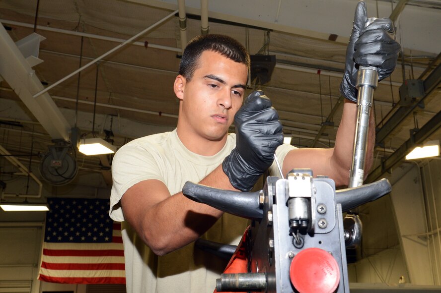 U.S. Air Force Airman 1st Class Sohail (so-HAIL) Sayeed (SIGH-eed), 20th Equipment Maintenance Squadron aircraft armament crew member, tightens a bolt on a MAU-12 heavy duty ejector rack, Dec. 17, 2013, Shaw Air Force Base, S.C. Sayeed exemplifies the Air Force core values by being a good wingman, furthering his educational goals, and volunteering whenever he can. (U.S. Air Force photo by Airman 1st Class Jonathan Bass/Released)