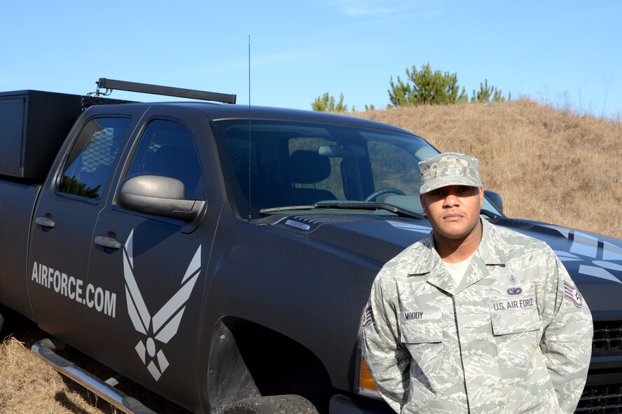 Staff Sgt. Cederick Moody, 337th Recruiting Squadron Marketing NCO, stands in front of the newly transformed 2012 Chevrolet Silverado 2500 recruiting vehicle Dec. 13, 2013, at Shaw Air Force Base, S.C. The squadron marketing team developed the new “Battlefield Airman” concept for the truck that will be used regularly across the squadron’s two-state recruiting territory. (U.S. Air Force photo by Senior Airman Laura L. Valentine/Released)