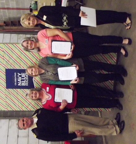 Capt. Timothy Sparks, Joint Base Charleston deputy commander, and Beth Munoz, Navy Exchange general manager (right), congratulate Teresa Patterson, Pam Linn and Sharon Guerra during the Navy Exchange’s annual Christmas Award Appreciation Luncheon Dec. 17, 2013, at Joint Base Charleston – Weapons Station. Patterson, Linn and Guerra received the Superior Accomplishment Recognition awards for their work. (U.S. Navy photo/April Ware)
