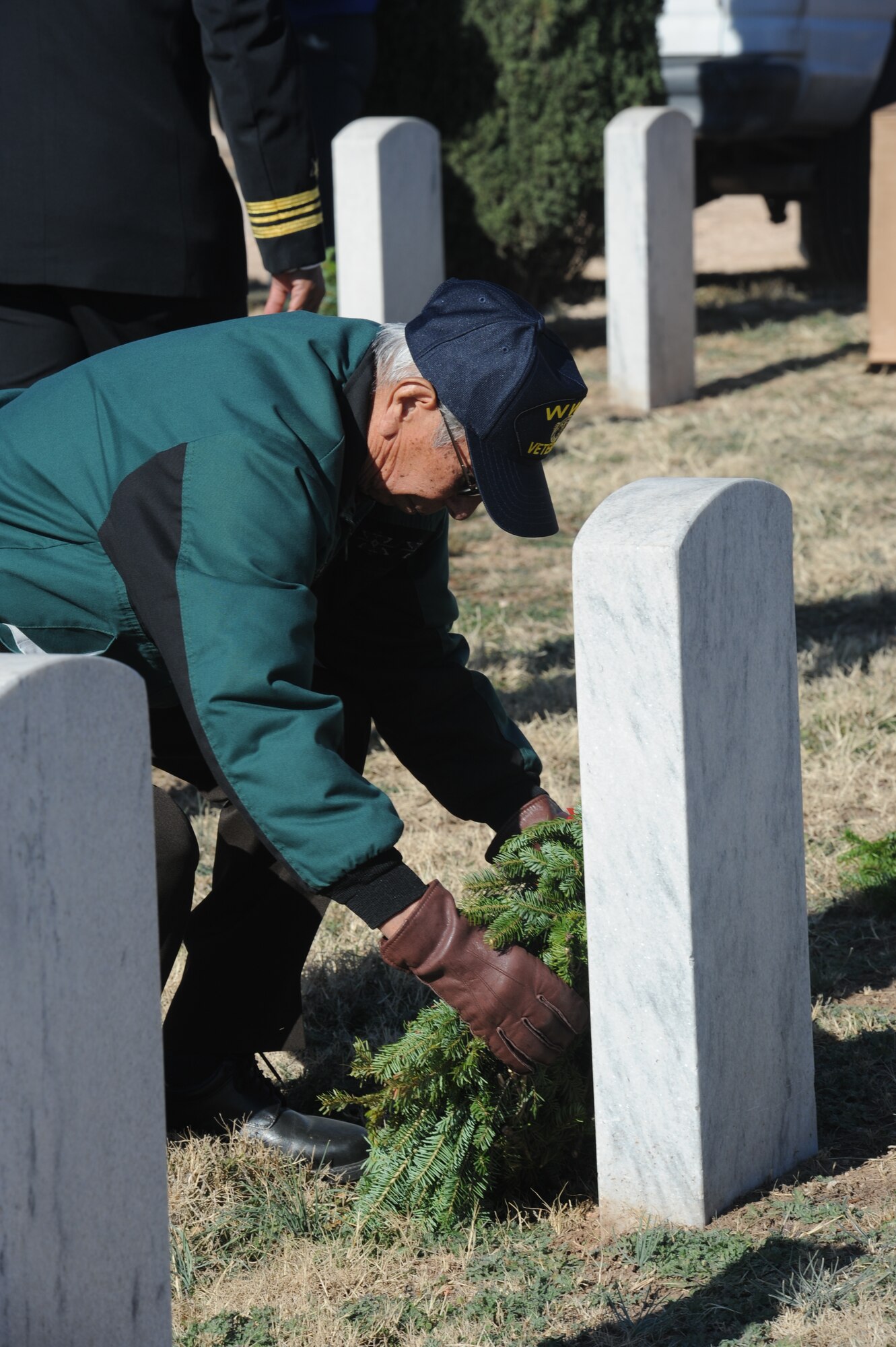 SAN ANGELO, Texas – Luciano Gonzales, World War II Army veteran, places a wreath at a grave during the Wreaths Across America event at the Belvedere Cemetery Dec. 14. In 2007, the Worcester family, veterans, individuals and various groups who had contributed over the years formed Wreaths Across America. (U.S. Air Force photo/ Staff Sgt. Laura R. McFarlane)