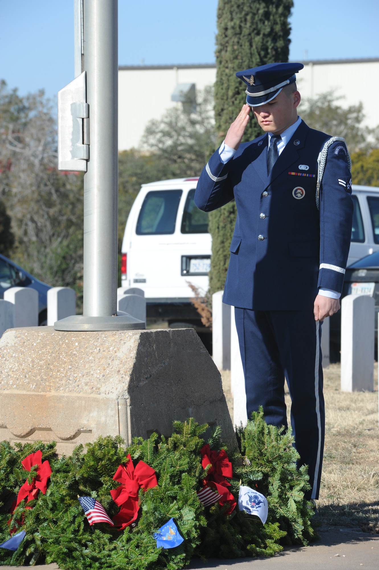 SAN ANGELO, Texas – Airman 1st Class Aziz Sarbashev, 17th Force Support Squadron, renders a salute after placing a wreath at the base of the flagpole in the Belvedere Cemetery during the Wreaths Across America ceremony Dec. 14. Wreaths from all services including the Merchant Marines and a Prisoners of War Missing in Action wreath were placed at the flagpole. (U.S. Air Force photo/ Staff Sgt. Laura R. McFarlane)