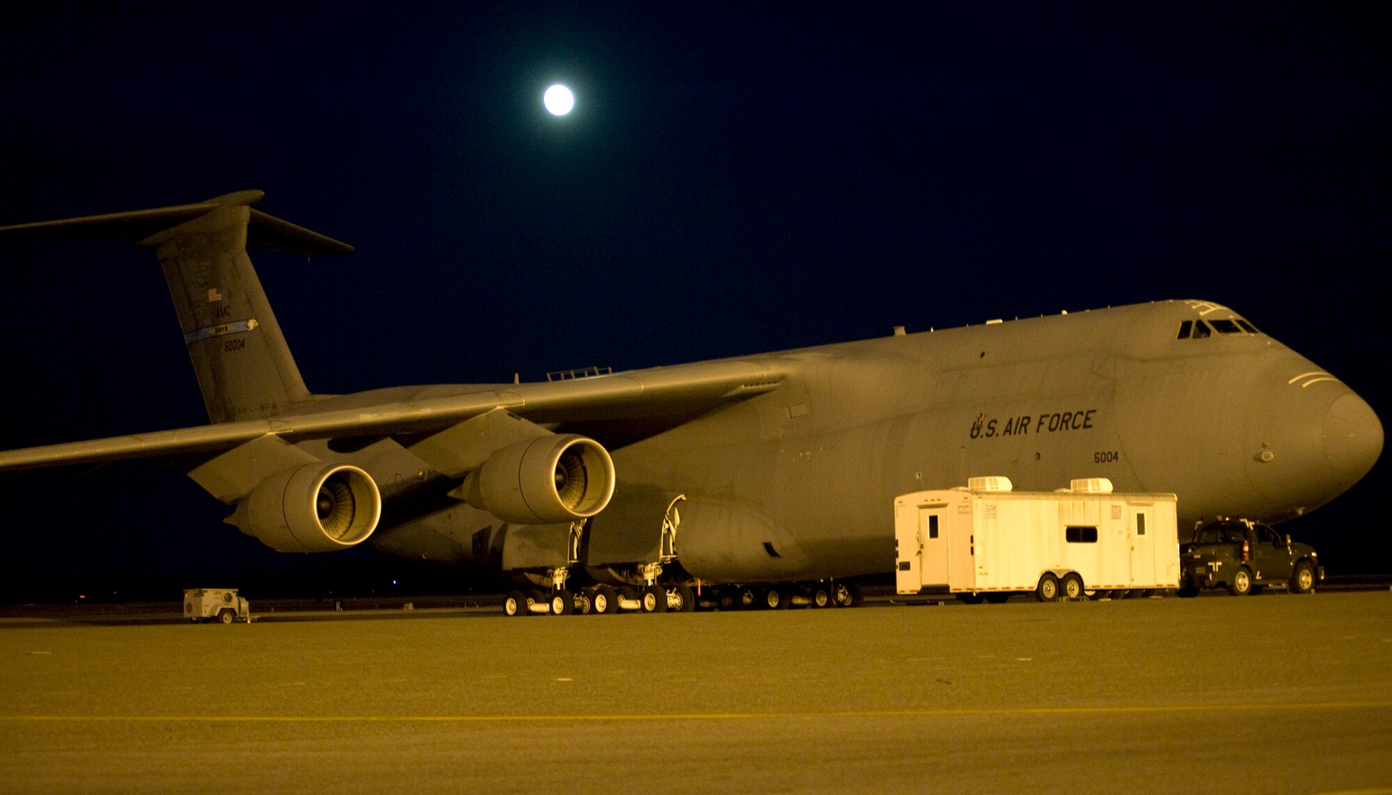 A C-5M Super Galaxy sits on the flight line as the moon shines overhead Dec. 16, 2013, at Dover Air Force Base, Del. Even though the full moon was bright, Team Dover was still hard at work. (U.S. Air Force
photo/Tech. Sgt. Chuck Walker)
