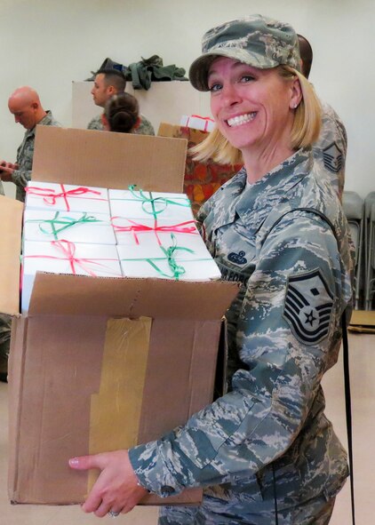 Master Sgt. Tricia Pinola, the 96th Operations Support Squadron first sergeant heads out for a delivery at the annual Team Eglin Cookie Caper Dec. 17.  More than 650 dozen cookies were boxed up for Eglin's dorm residents.  (U.S. Air Force photo/Irene Freiberg)
