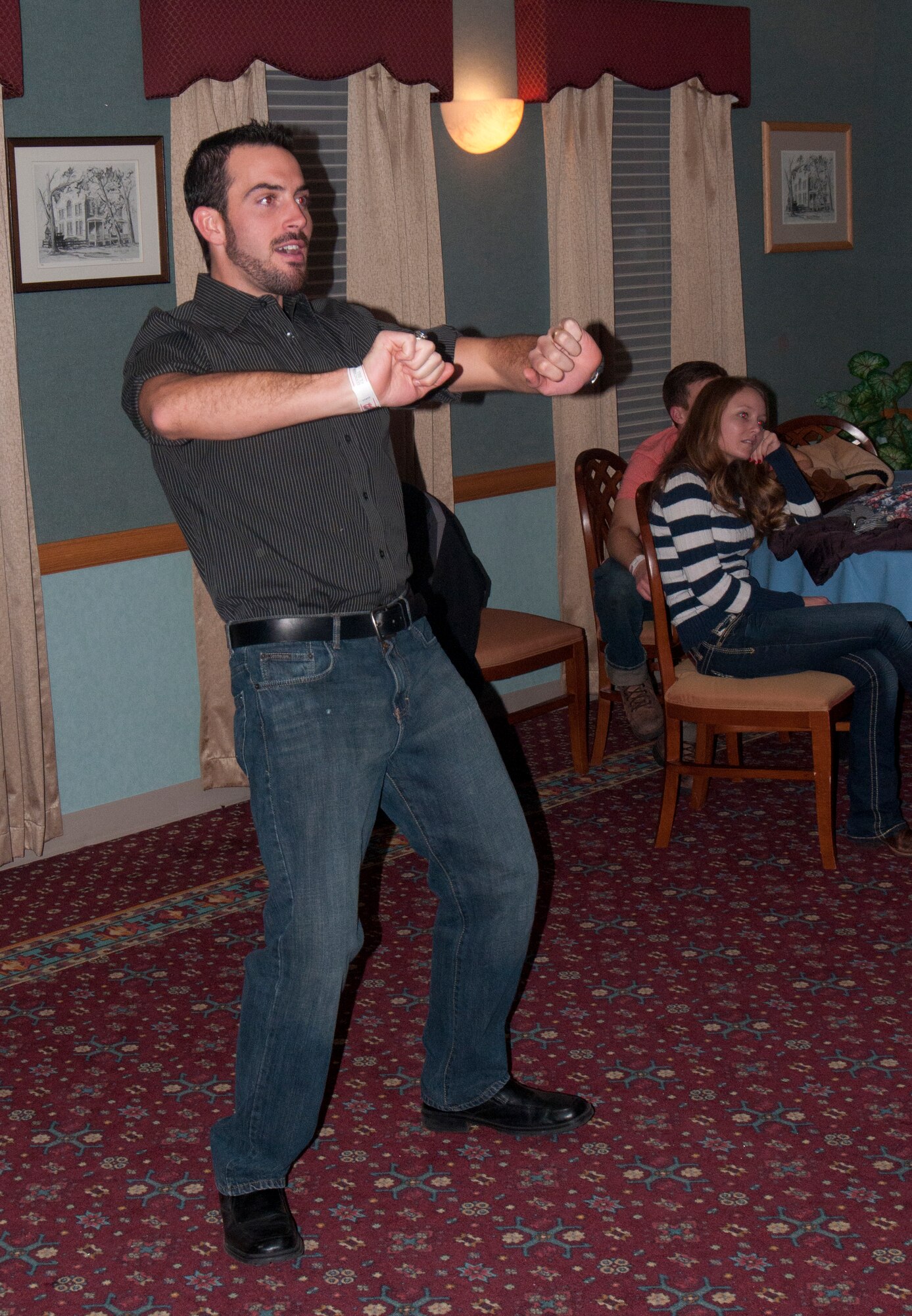 Anthony Ornella, husband of 2nd Lt. Christen Ornella, 90th Missile Wing Public Affairs, competes in a dance video game competition held during the 90th Missile Wing holiday party in the Trail’s End Club Dec. 15, 2013. (U.S. Air Force photo by Airman 1st Class Jason Wiese)