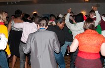 Mighty Ninety personnel and their loved ones dance in the Trail’s End Club during the 90th Missile Wing holiday party Dec. 15, 2013. (U.S. Air Force photo by Airman 1st Class Jason Wiese)