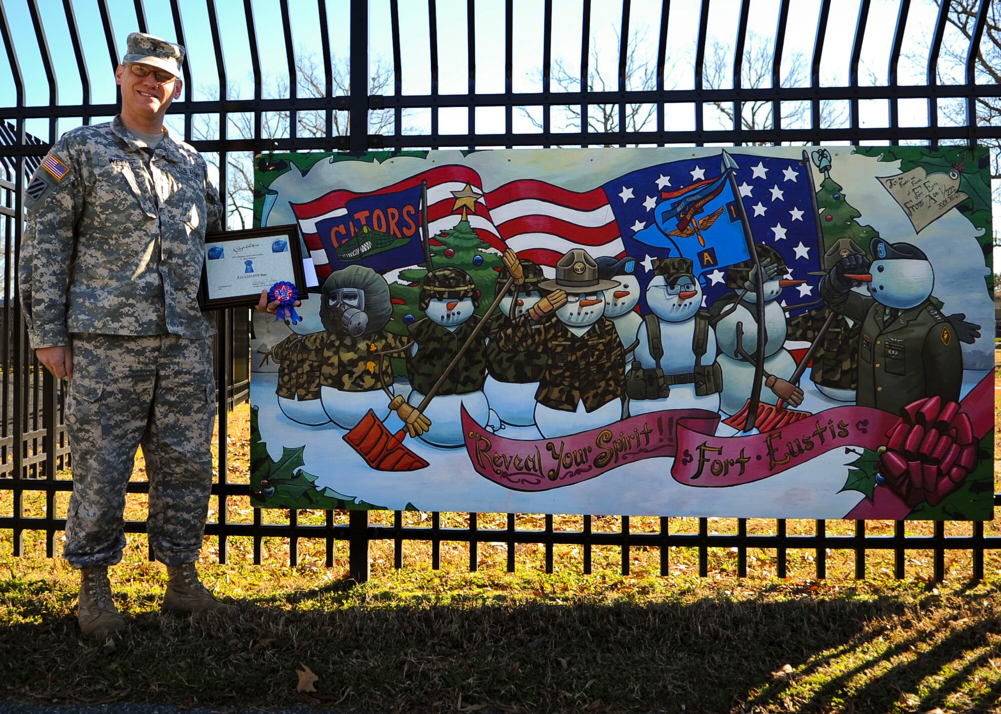 U.S. Army Chief Warrant Officer 3 David Wells, A Company, 1st Battalion, 222nd Aviation Regiment executive officer, received first place honors within his unit during the Holiday Card Lane competition award ceremony at Fort Eustis, Va., Dec. 13, 2013. Joint Task Force Civil Support  and A Company, 1-210th Avn. Rgt. were awarded second and third, respectively. (U.S. Air Force photo by Airman 1st Class Austin Harvill/Released)