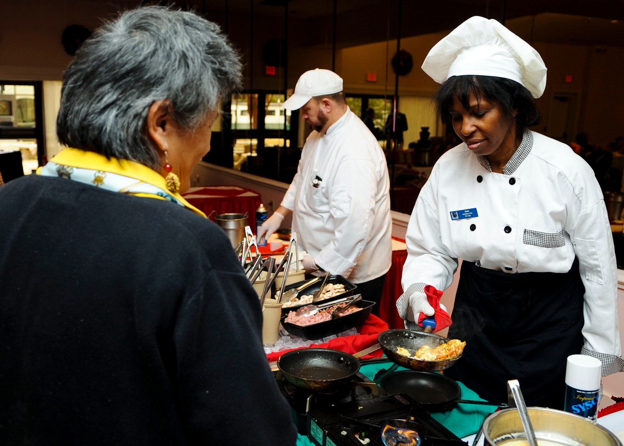 Jean Moody, Fort Eustis Club assistant chef, prepares an omelet during the "Breakfast with Santa" event at Fort Eustis, Va., Dec. 14, 2013. The club offered a full breakfast as well as a dessert bar, fresh omelets, refreshments and holiday music for the occasion. (U.S. Air Force photo by Airman 1st Class Austin Harvill/Released)