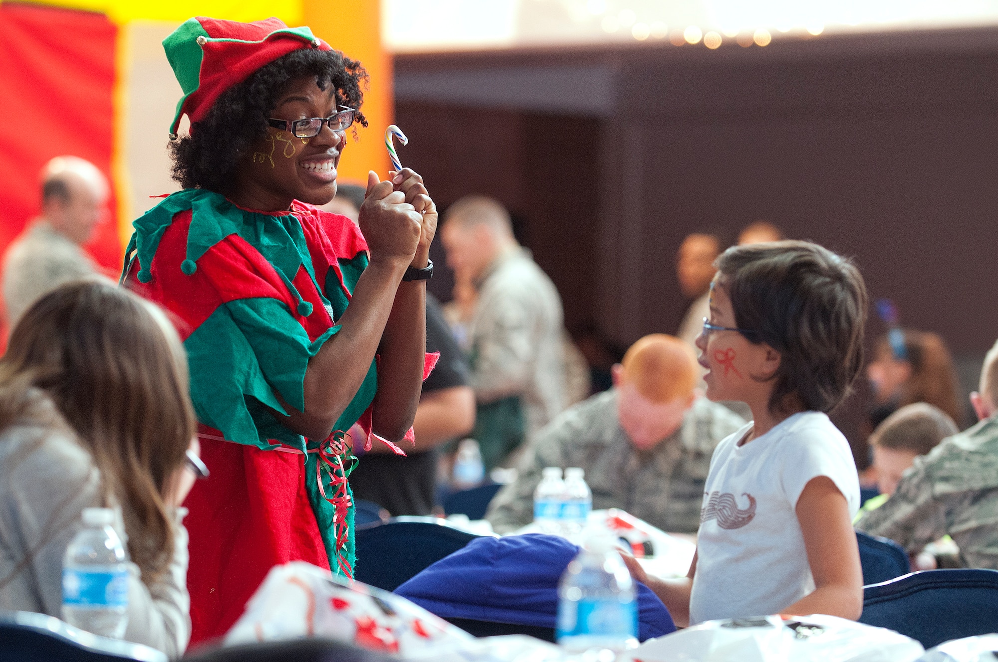 Ginger the Elf entertains Victoria Balser, 8, during Operation Provide Joy in the Fall Hall Community Center Dec. 14, 2013. Every year children from local families are invited to F.E. Warren Air Force Base, Wyo., for a morning of games, refreshments and presents. (U.S. Air Force photo by R.J. Oriez)