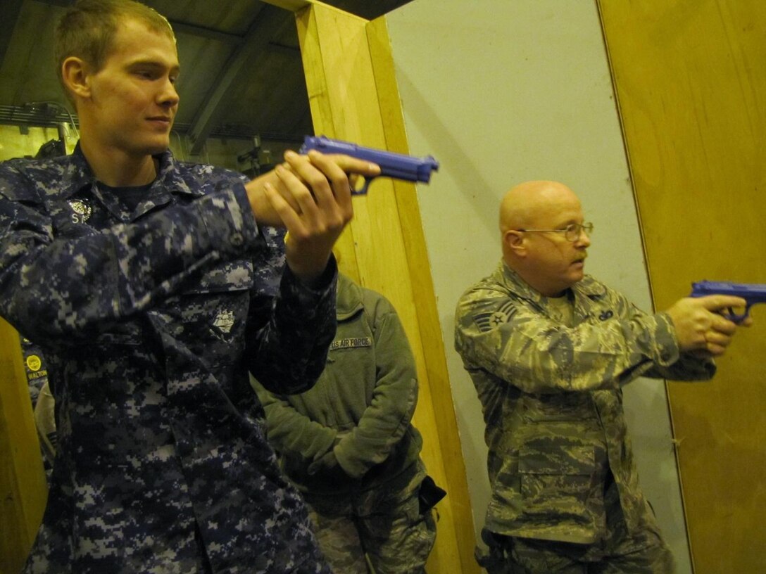 Master at Arms Seaman Apprentice Dillon Statler, Naval Security Force Pittsburgh, and Staff Sergeant David Griggs, 911th Security Forces, Pittsburgh International Airport Air Reserve Station, prepare to clear a room during a joint service active shooter training exercise, Dec. 6, 2013 held at the Pennsylvania Air National Guard’s 171st Air Refueling Wing’s “shoot house.” (Photo courtesy of SrA Shawnee Fair, 911th Security Forces)