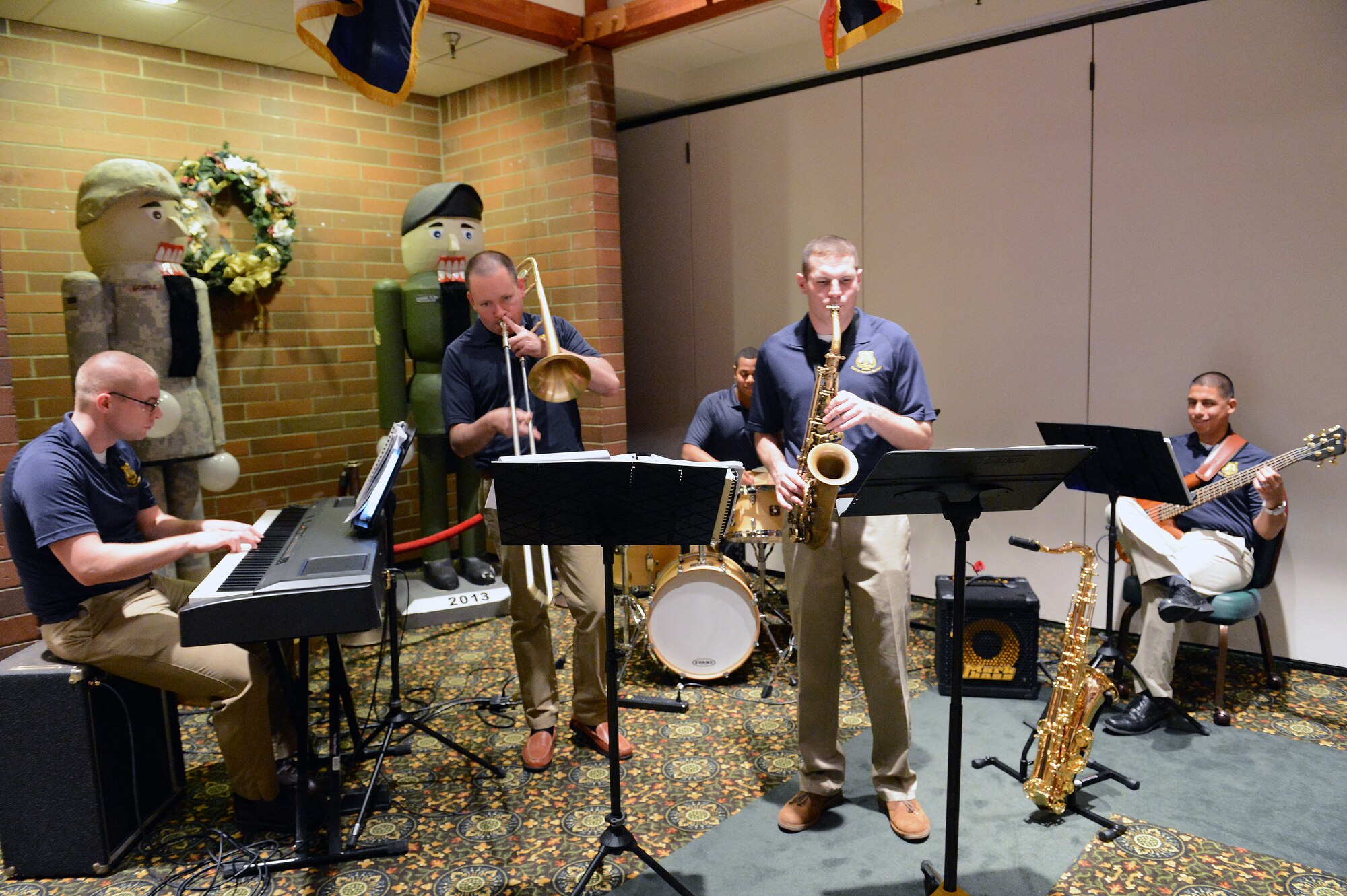 The 56th Army Band jazz combo play a Christmas carol at the civic leaders holiday reception Dec. 15, at Joint Base Lewis-McChord, Wash. Civic leaders enjoyed live music, a social hour and hors d'oeuvres. (U.S. Air Force photo/ Airman 1st Class Jacob Jimenez)