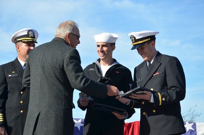 Capt. John Fahs, Naval Nuclear Power Training Command commanding officer (left) and Frederick Bolz from the Fleet Reserve Society, recognize Petty Officer 3rd Class Zachary Dykeman and Ens. Daniel Detoma, as Honormen for graduating class 1305 during a ceremony at NNPTC at Joint Base Charleston – Weapons Station, Dec. 13, 2013. The Class Honormen awards are given to the Sailors with the highest grade point average. Detoma was also named the Vice Adm. Behrens Award winner which is given to the office with the highest grade point average. (U.S. Navy photo/ Petty Officer 3rd Class Jason Pastrick)