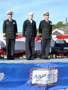 Capt. John Fahs, Naval Nuclear Power Training Command commanding officer (left) and Vice Adm. David Buss, commander, Naval Air Forces, Commander, Naval Air Force, U.S. Pacific Fleet, recognize Petty Officer 2nd Class Ry Conroy, an electrician’s mate at Naval Nuclear Power Training Command as the class Hard Charger. The Hard Charger award is presented to the Sailor that overcomes the most and works the hardest for his achievements. (U.S. Navy photo/Petty Officer 3rd Class Jason Pastrick) 