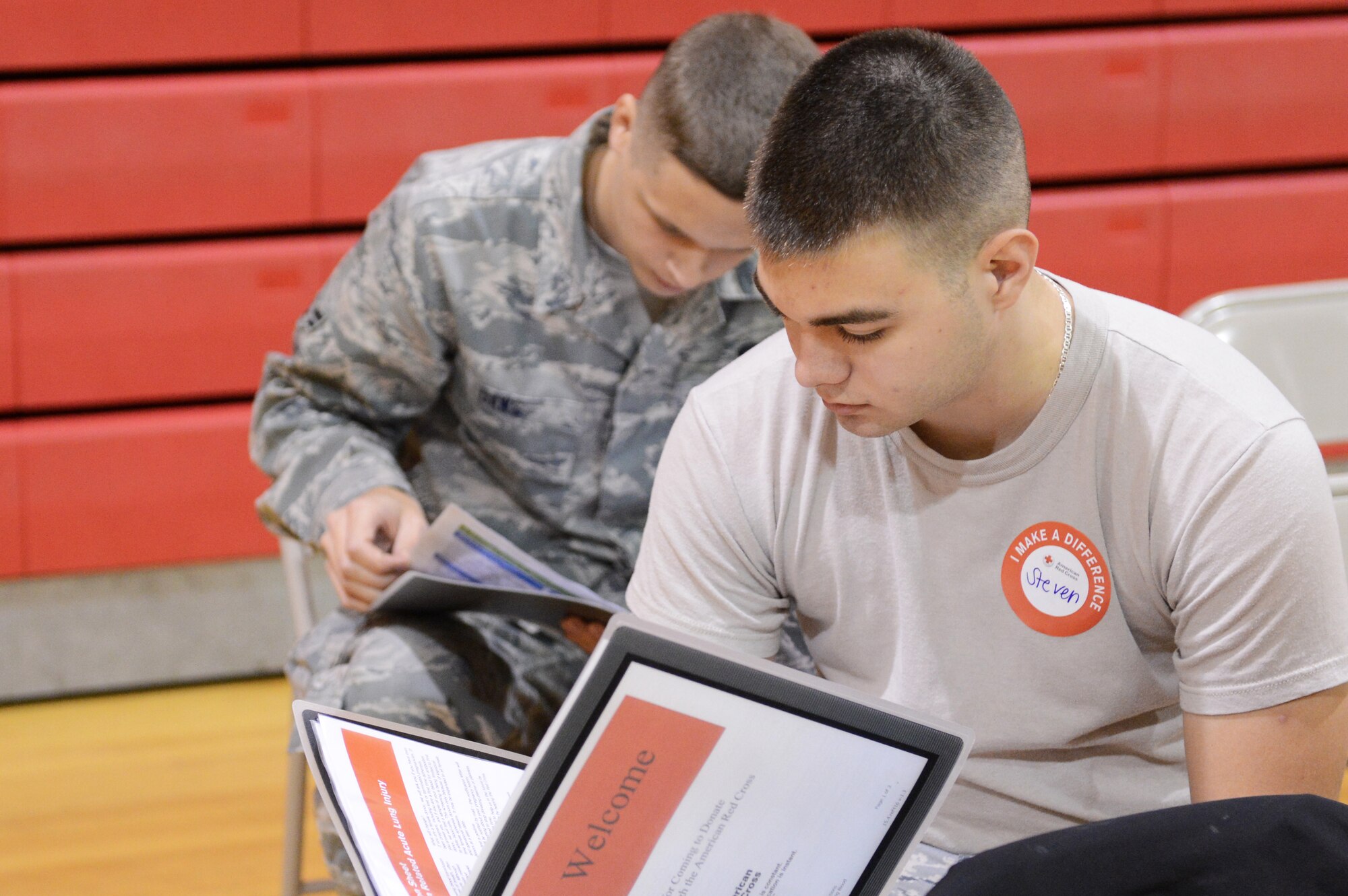 Two Airmen wait and prepare to donate blood in the fitness center Dec. 12, 2013, at Shaw Air Force Base, S.C. Eligible volunteers can donate every 56 days, or up to six times a year. (U.S. Air Force photo by Airman 1st Class Diana M. Cossaboom/Released)