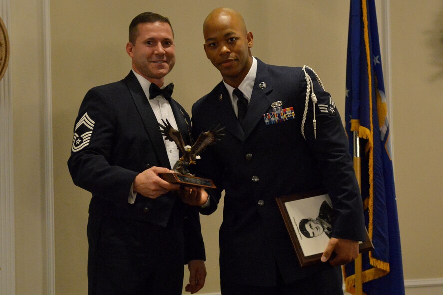 U.S. Air Force Chief Master Sgt. Michael Restivo, 20th Medical Group superintendent, presents Senior Airman Trevor Watts, 20th Component Maintenance Squadron electric warfare technician, with the John Levitow Award, Shaw Air Force Base, S.C., Dec. 12, 2013. The John Levitow Award, the highest in enlisted Professional Military Education, is earned by the Airman leadership school student with the highest average of instructor and student points.. (U.S. Air Force photo/ Senior Airman Ashley L. Gardner/Released)